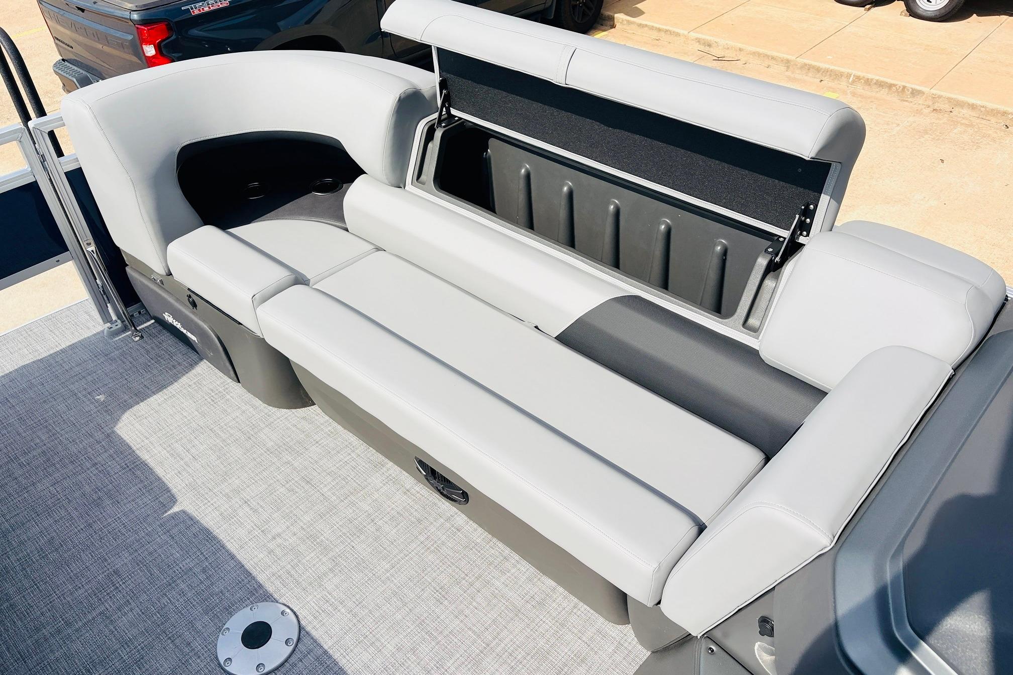 2026 Sun Tracker SportFish 22 DLX boat with spacious seating and storage compartment.