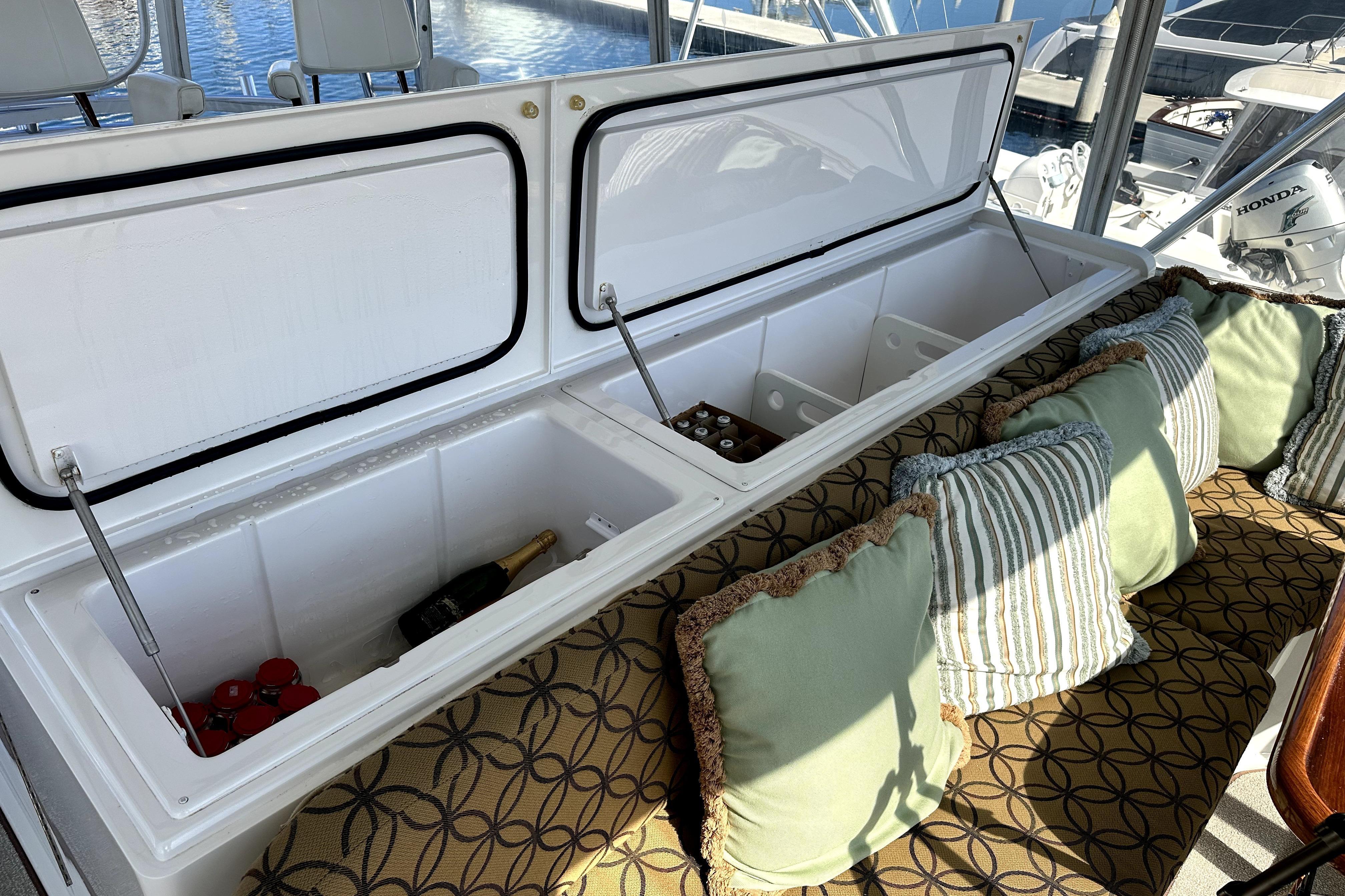 Open cooler with drinks and cushions on a 2003 Viking 61 Convertible yacht.