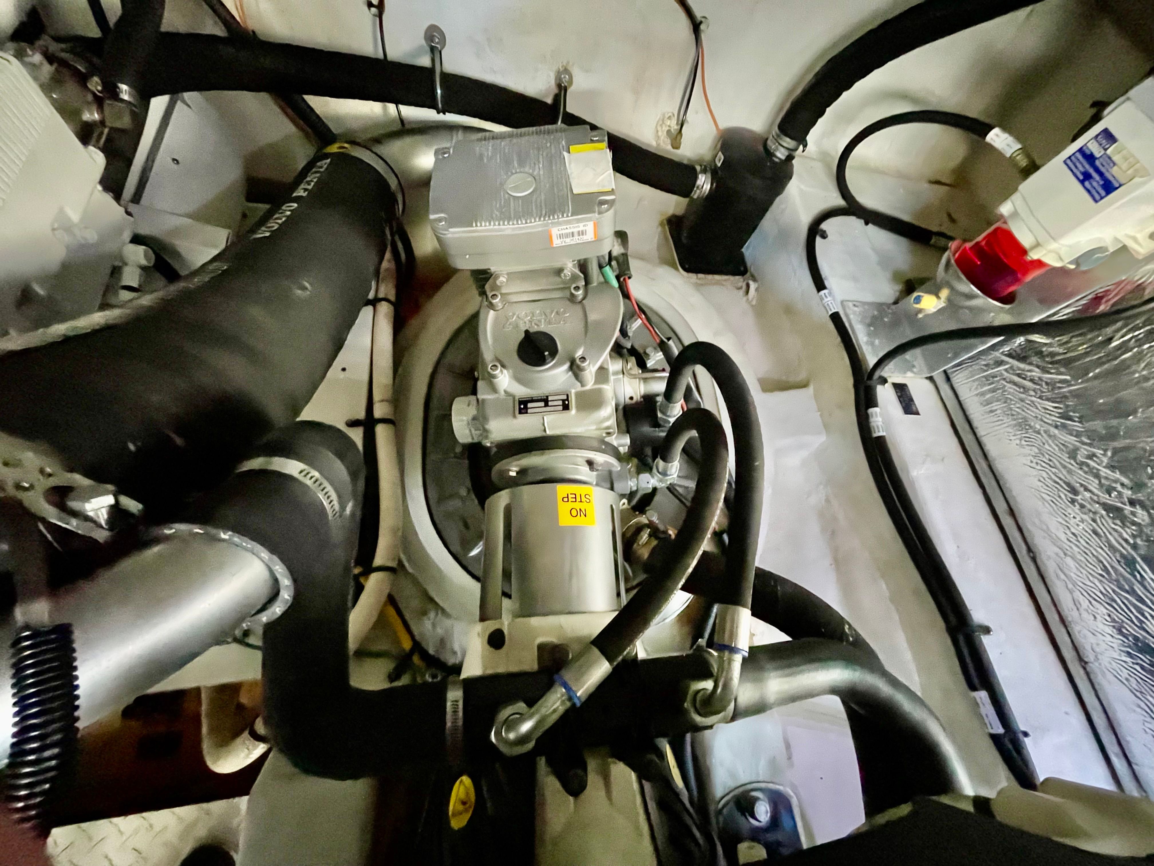 Engine room of the 2016 Cruisers Yachts 390 Express Coupe with hoses and cables.