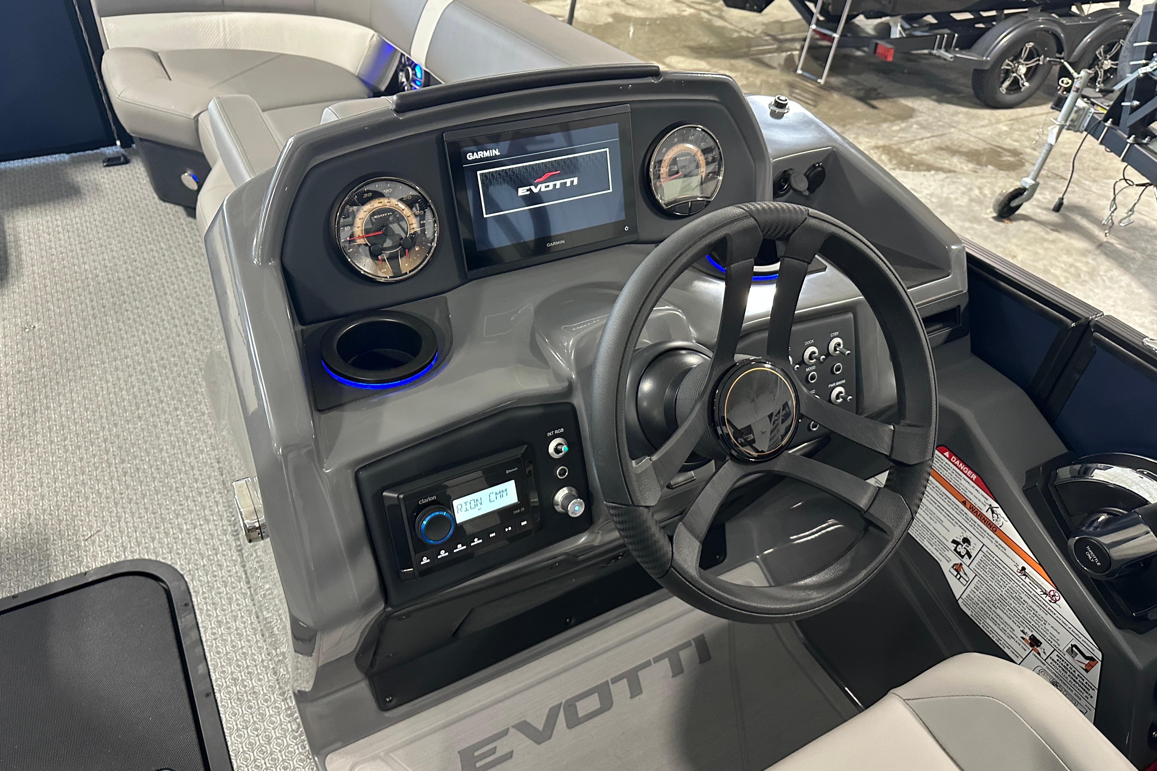 2026 Evotti 523QL boat dashboard with steering wheel and control panel.