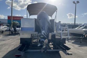 2023 Suntracker G3 Select 322 CC boat, rear view, parked outdoors under sunny sky.