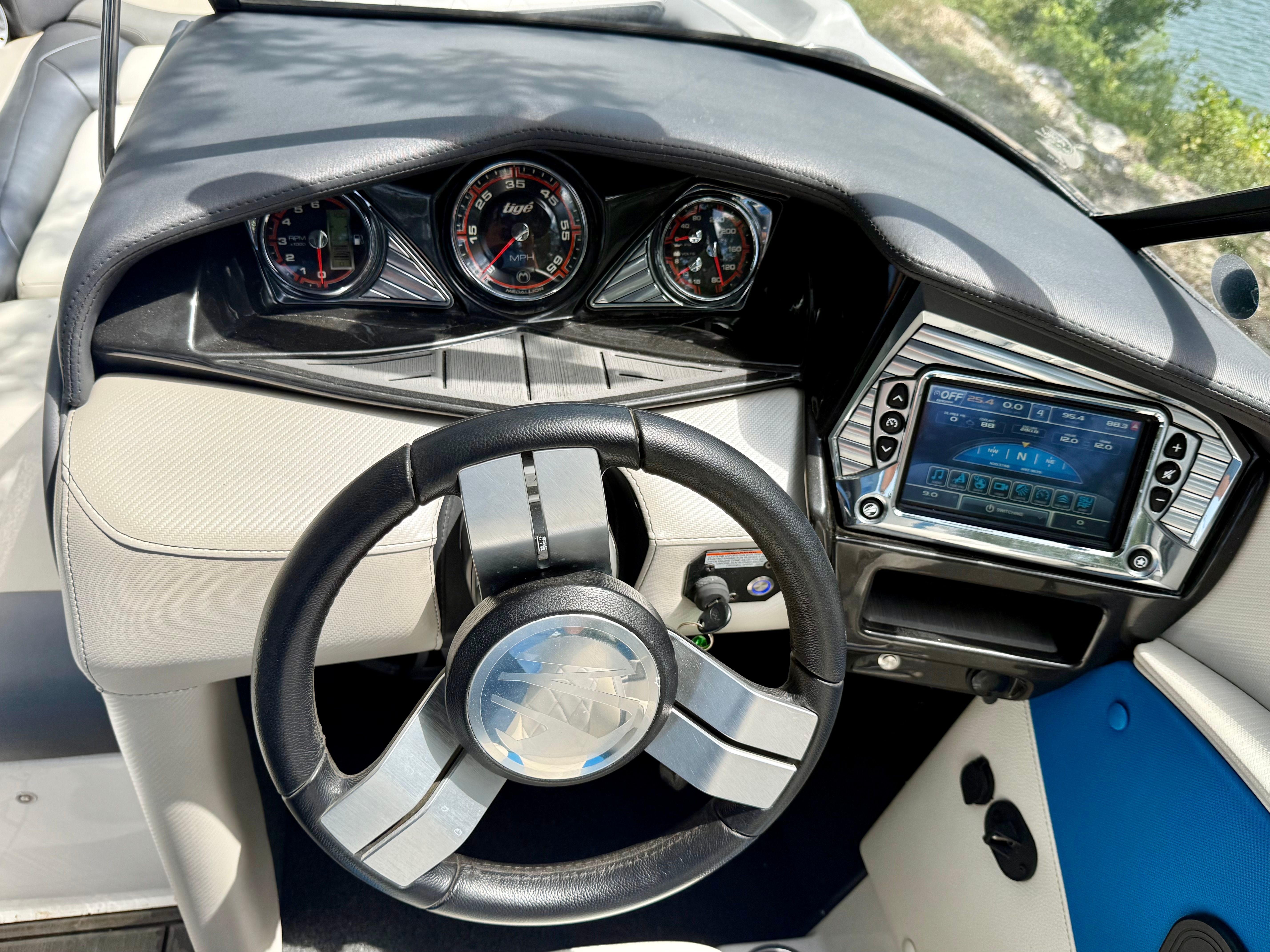The image shows the dashboard of a 2017 Tigé Z3 boat with steering wheel and instruments.