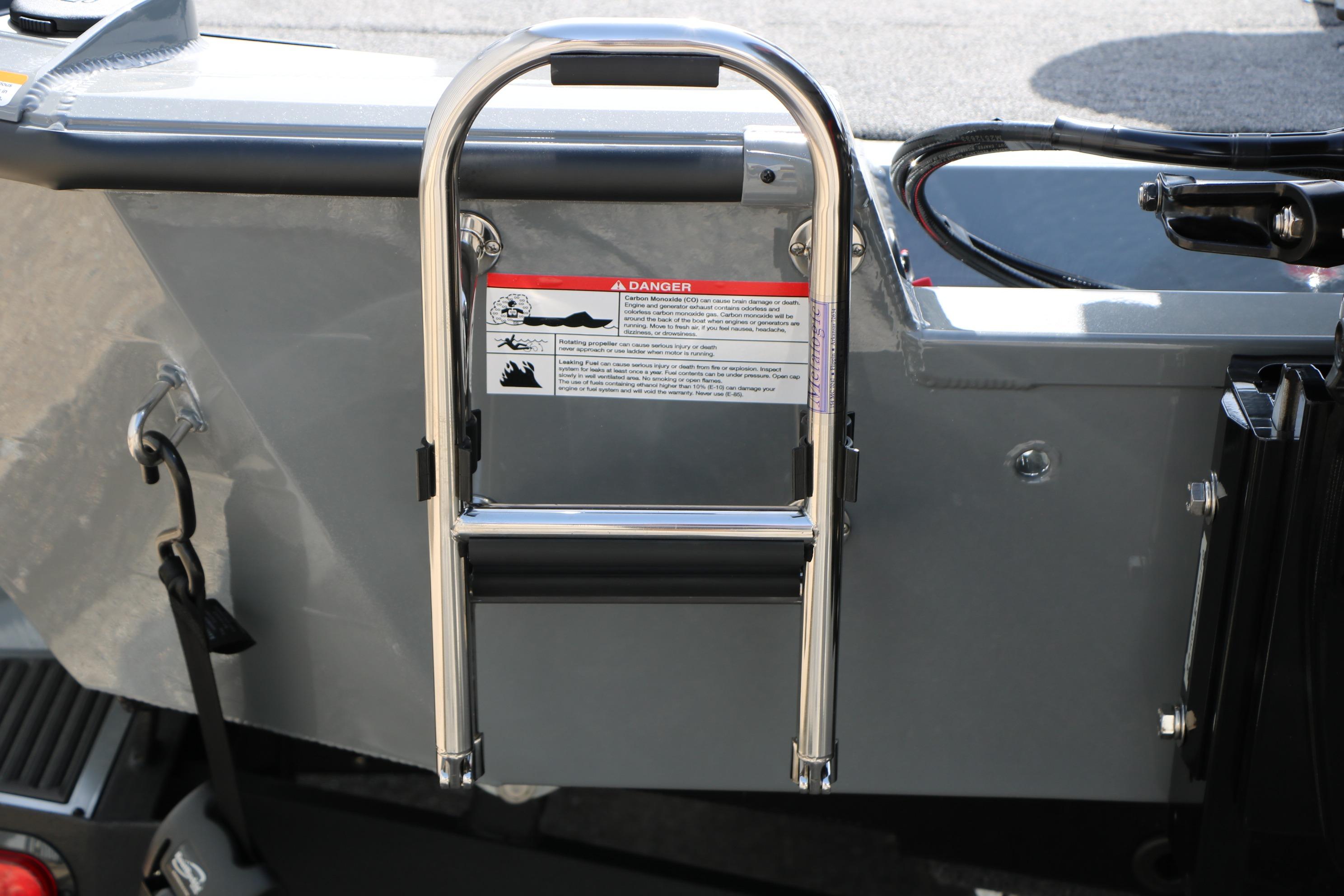 Stainless steel ladder on 2026 Vexus AVX1980 boat, featuring safety warning label.
