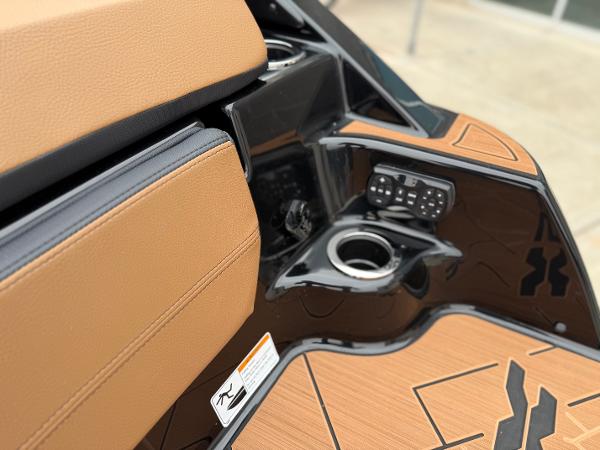 Interior of 2025 Yamaha Boats 255XD, featuring tan upholstery and control panel.