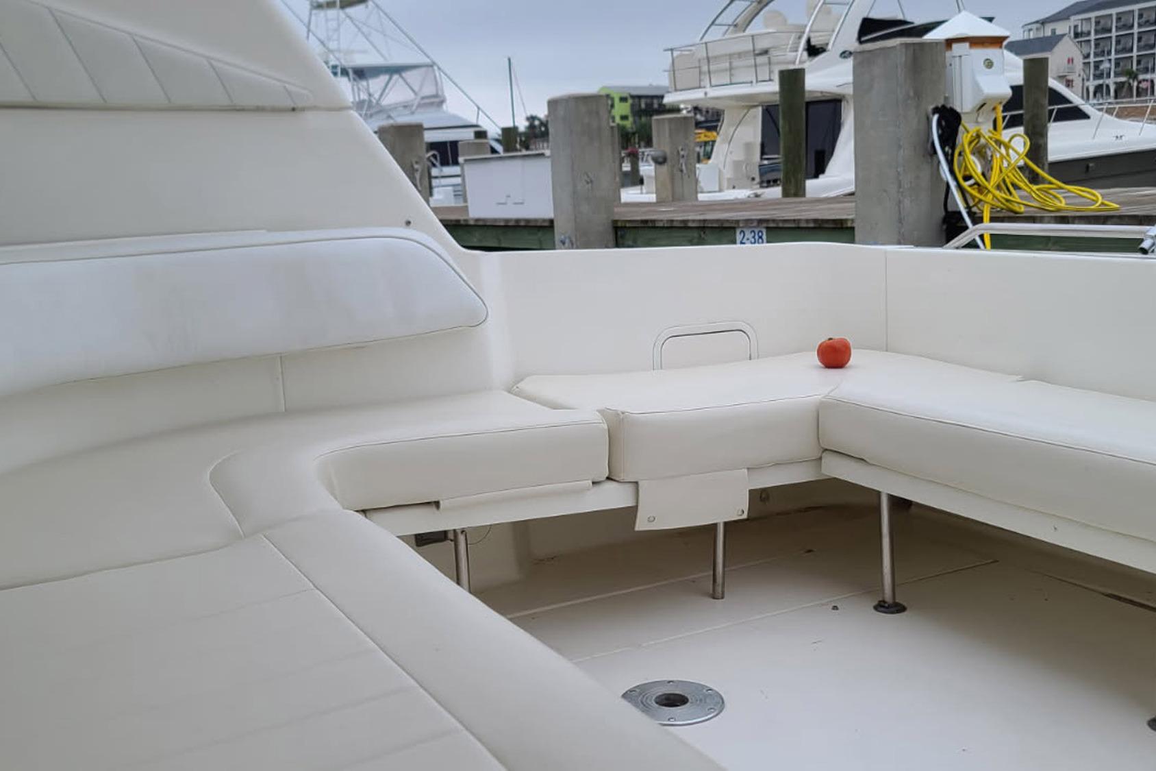 1998 Sea Ray Sundancer 400 yacht interior with white seating and a single red apple.