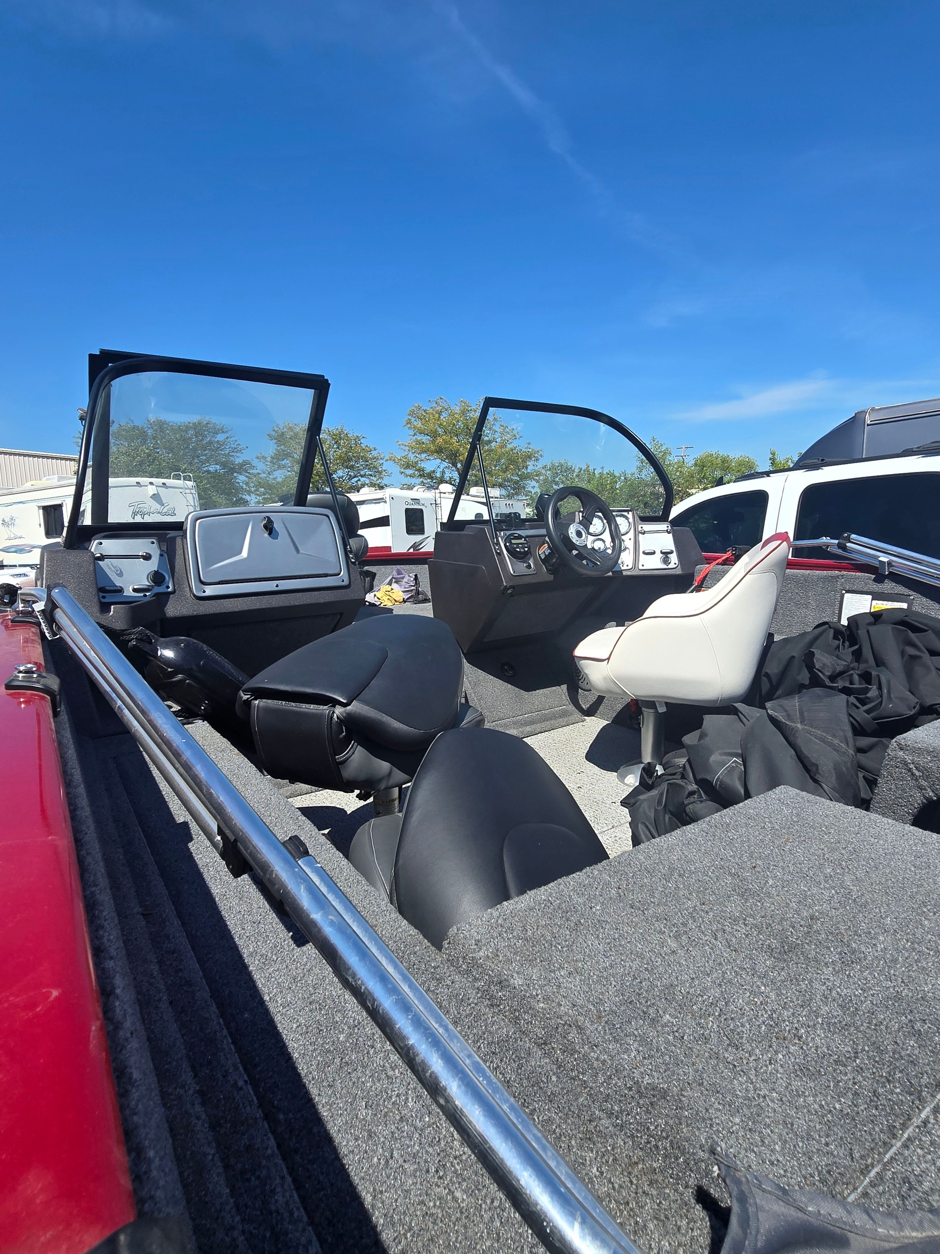 The image shows the cockpit of a 2023 Bass Tracker PGV175 with two seats and a steering wheel.