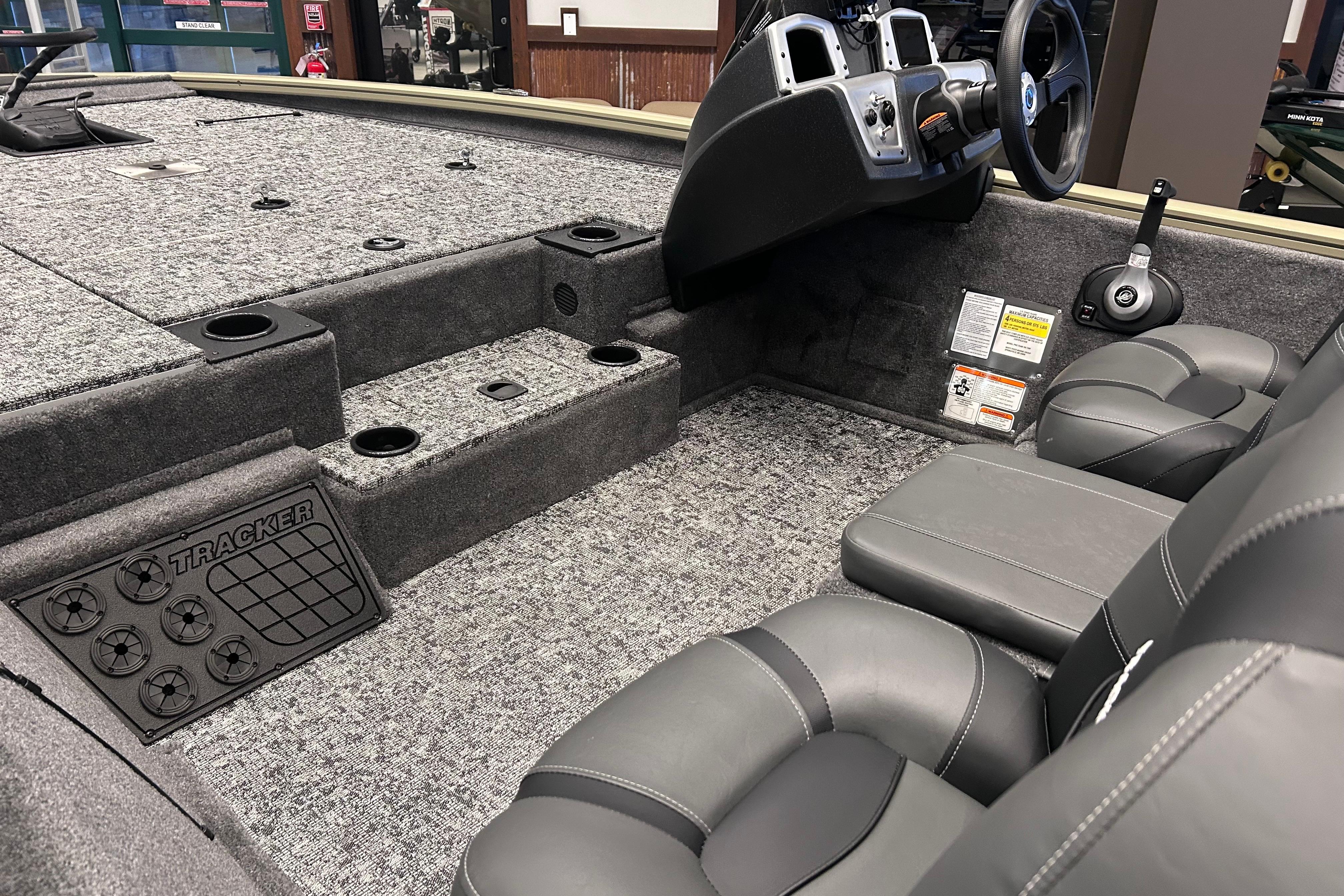 Interior of 2026 Tracker Pro Team 195 boat with gray seating and carpeted flooring.