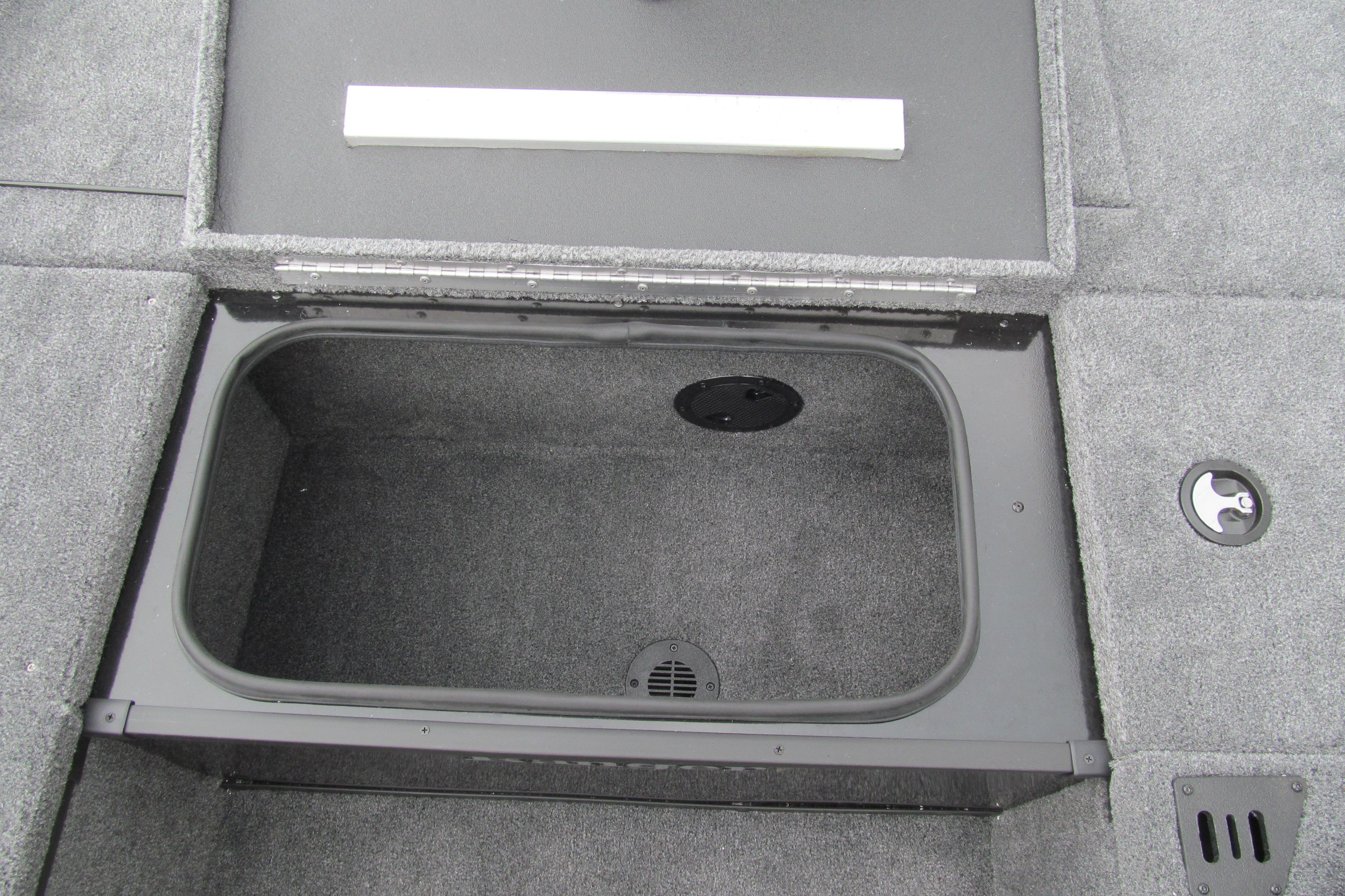 Open storage compartment in 2026 Ranger RT188C boat, featuring carpeted interior.