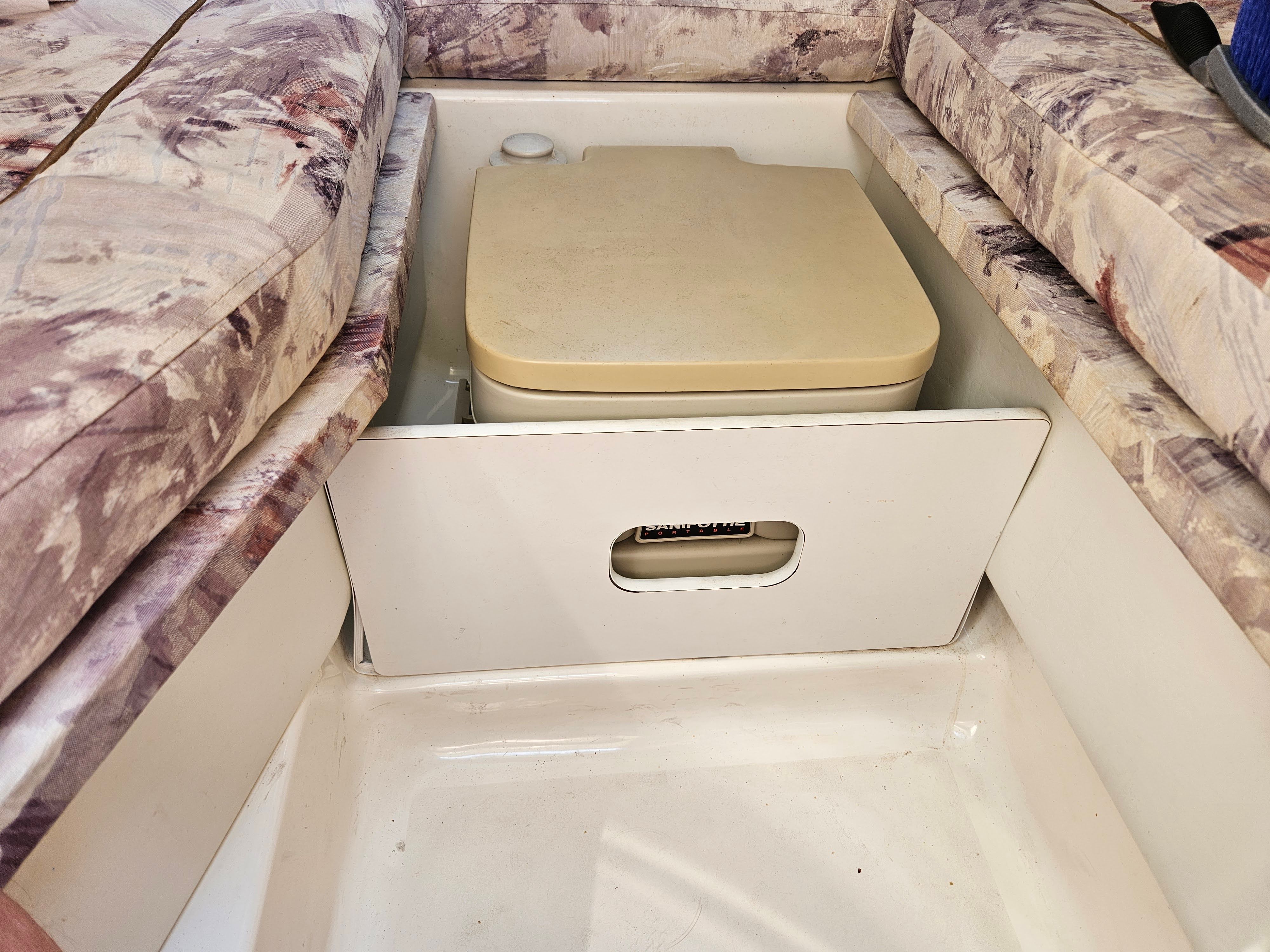 A portable boat toilet in a 1997 Sea Ray 230 Overnighter.