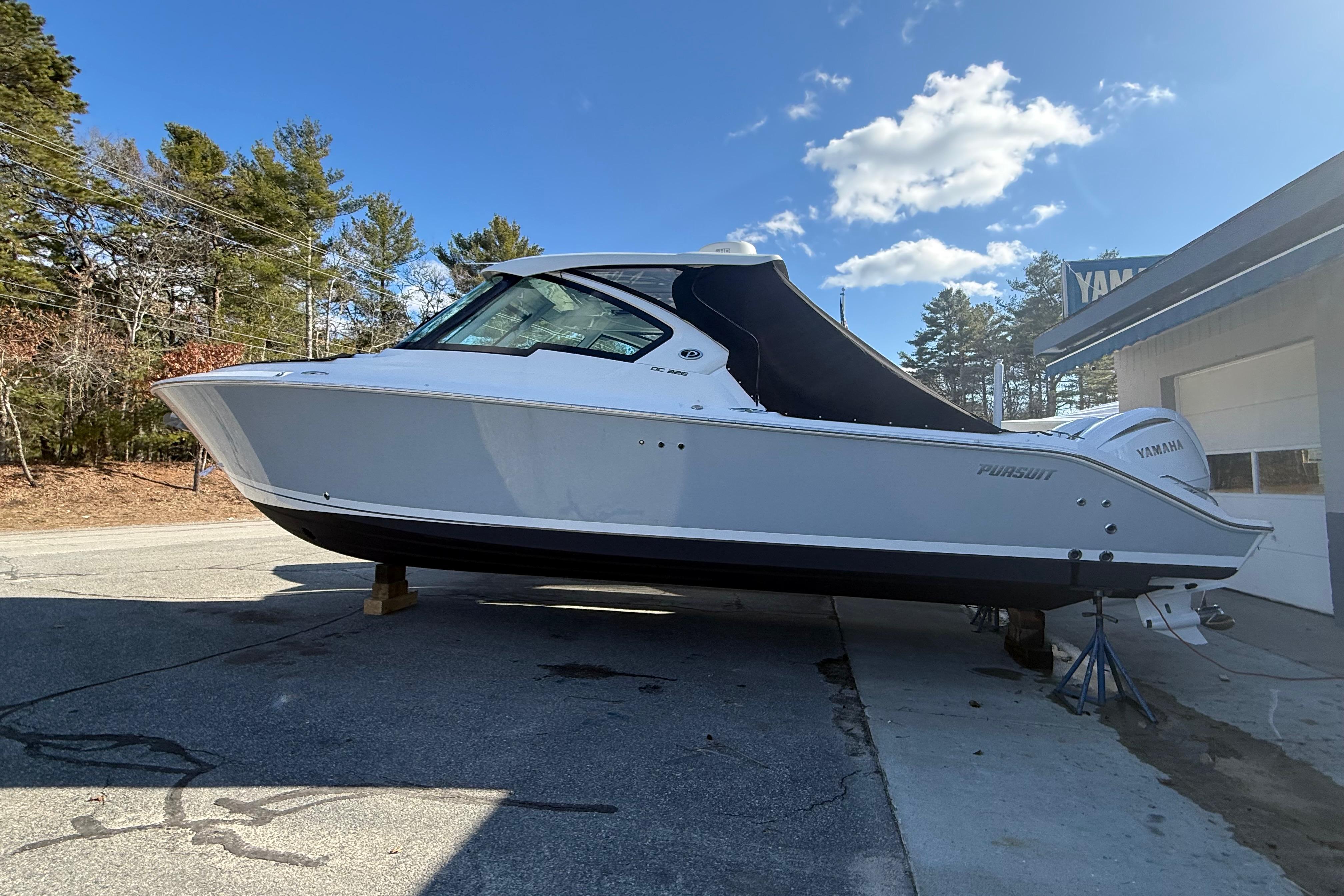 2022 Pursuit DC 326 Dual Console boat on display outdoors.