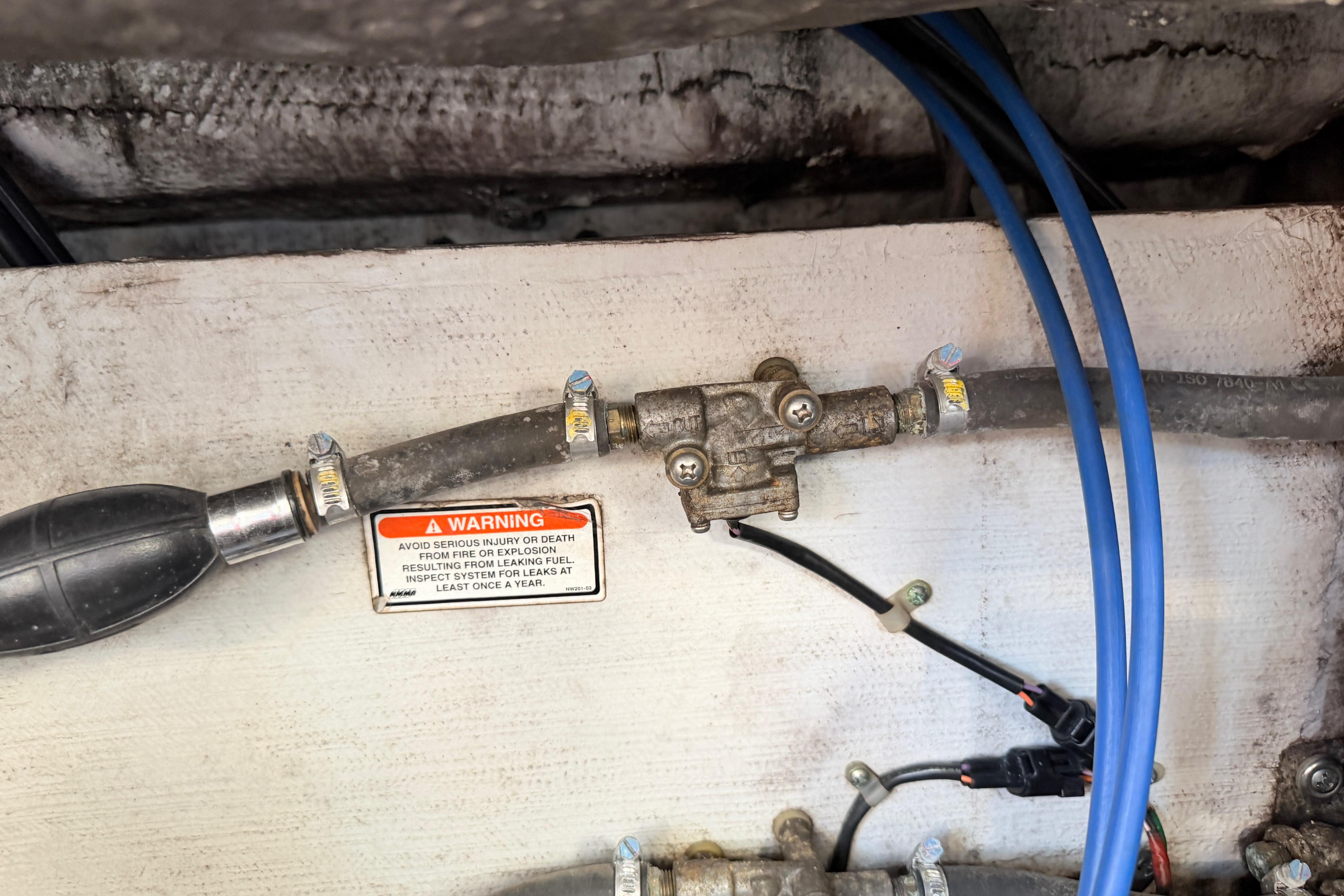 Fuel system components with warning label on 2004 Grady White 273 boat.