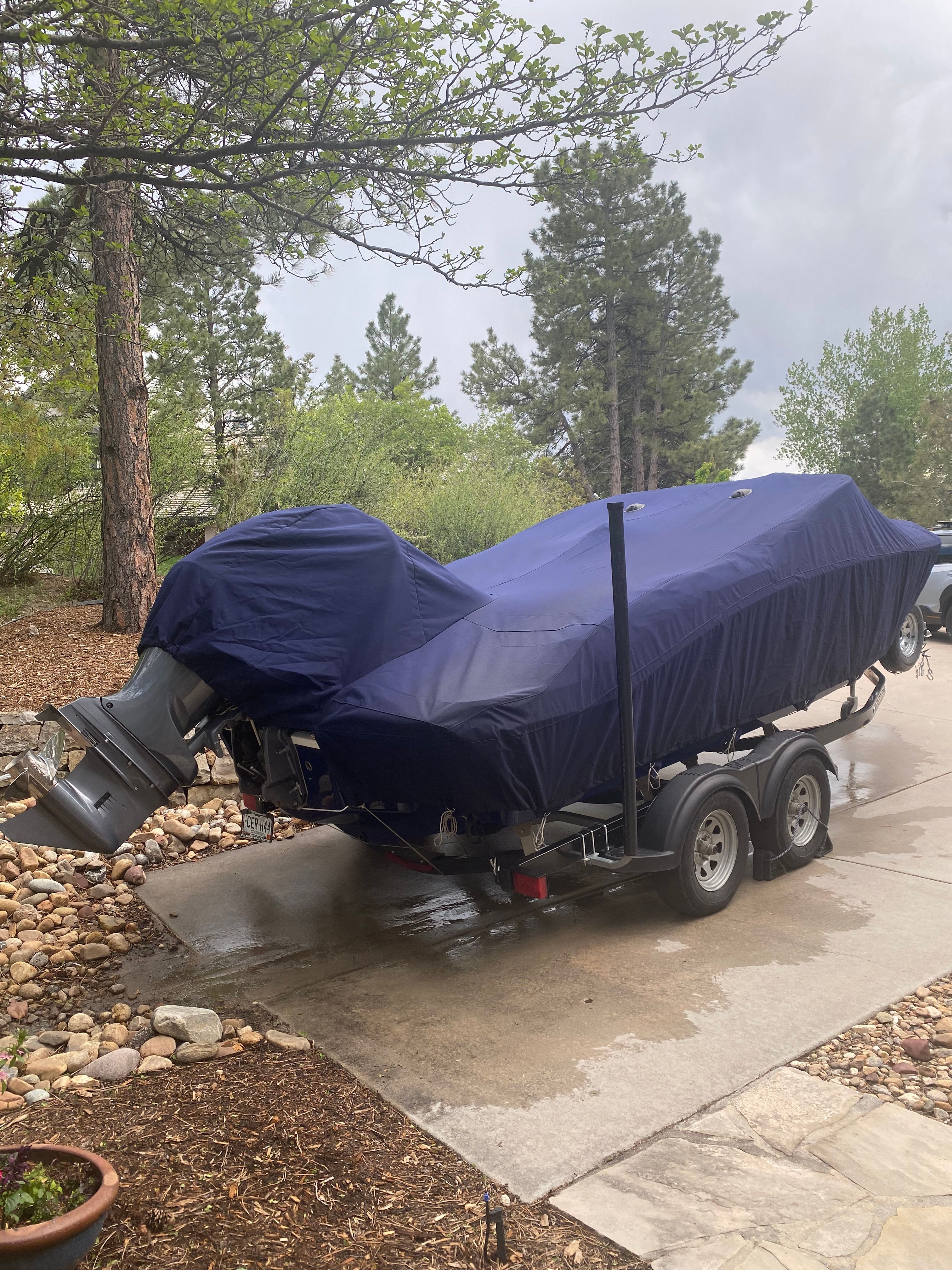 Covered Chaparral 21 SSi boat on trailer, 2020 model.