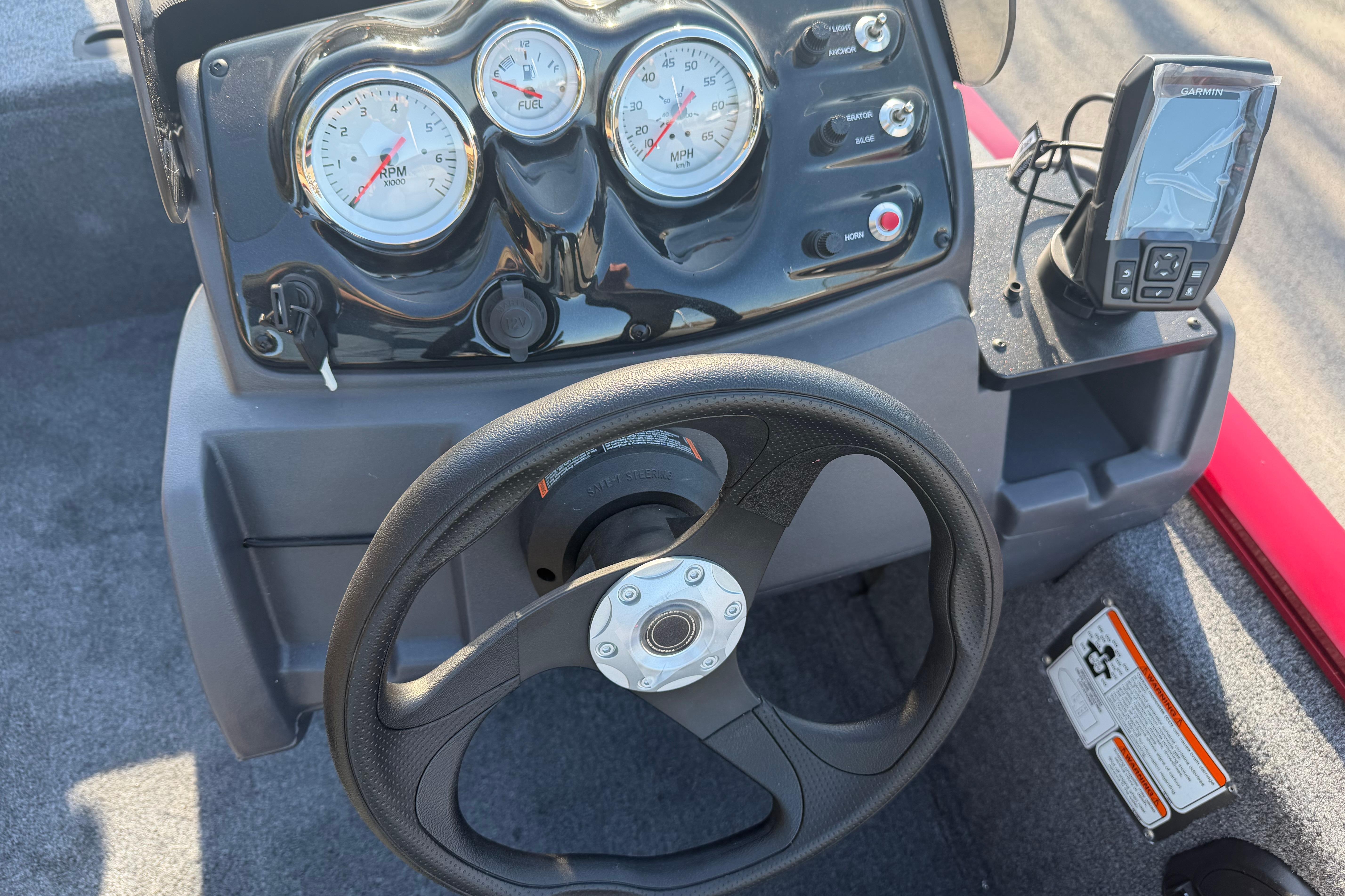 Steering console of 2026 Tracker Pro 170 boat with gauges and Garmin device.