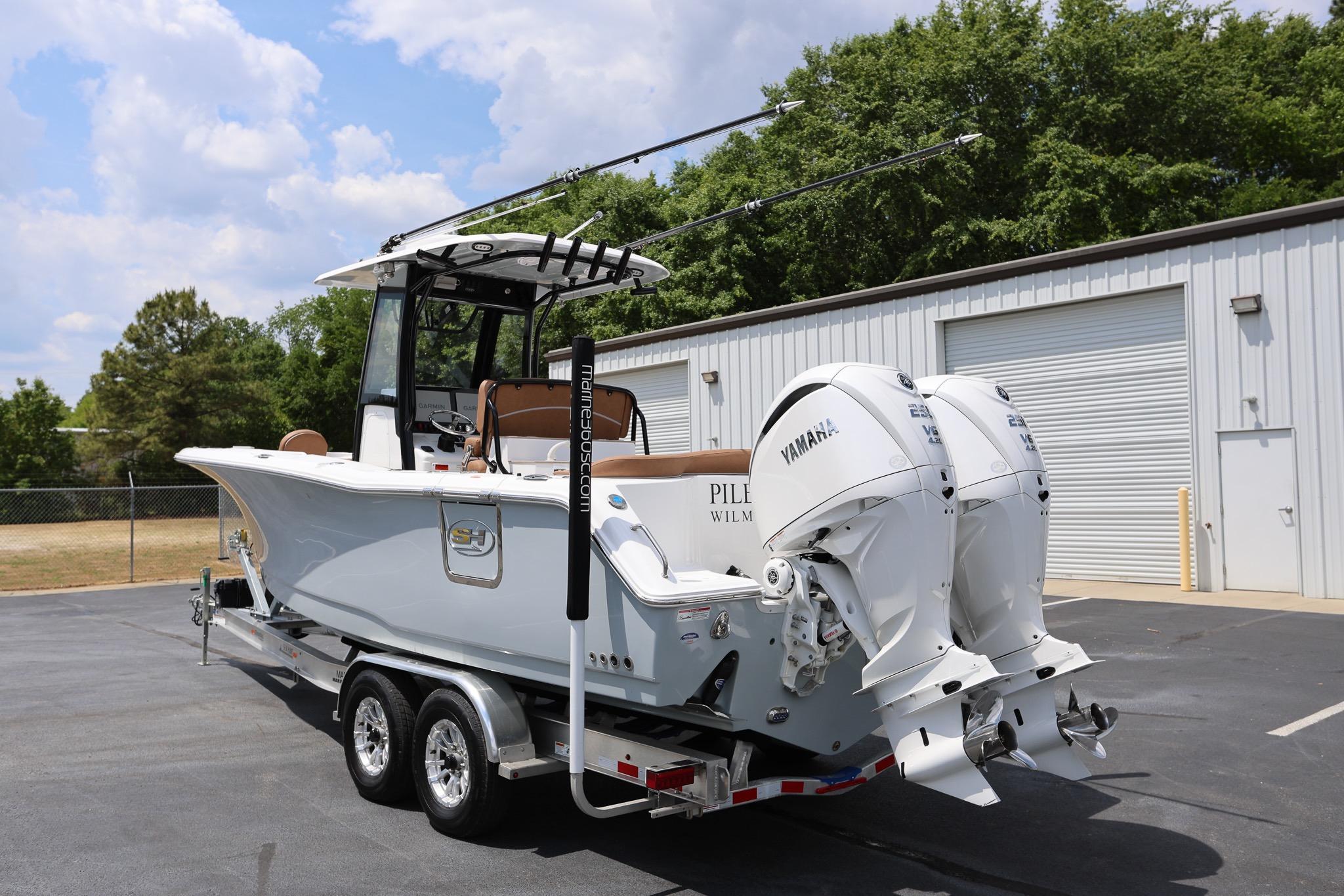 2024 Sea Hunt Ultra 275 SE boat with dual Yamaha engines on a trailer.