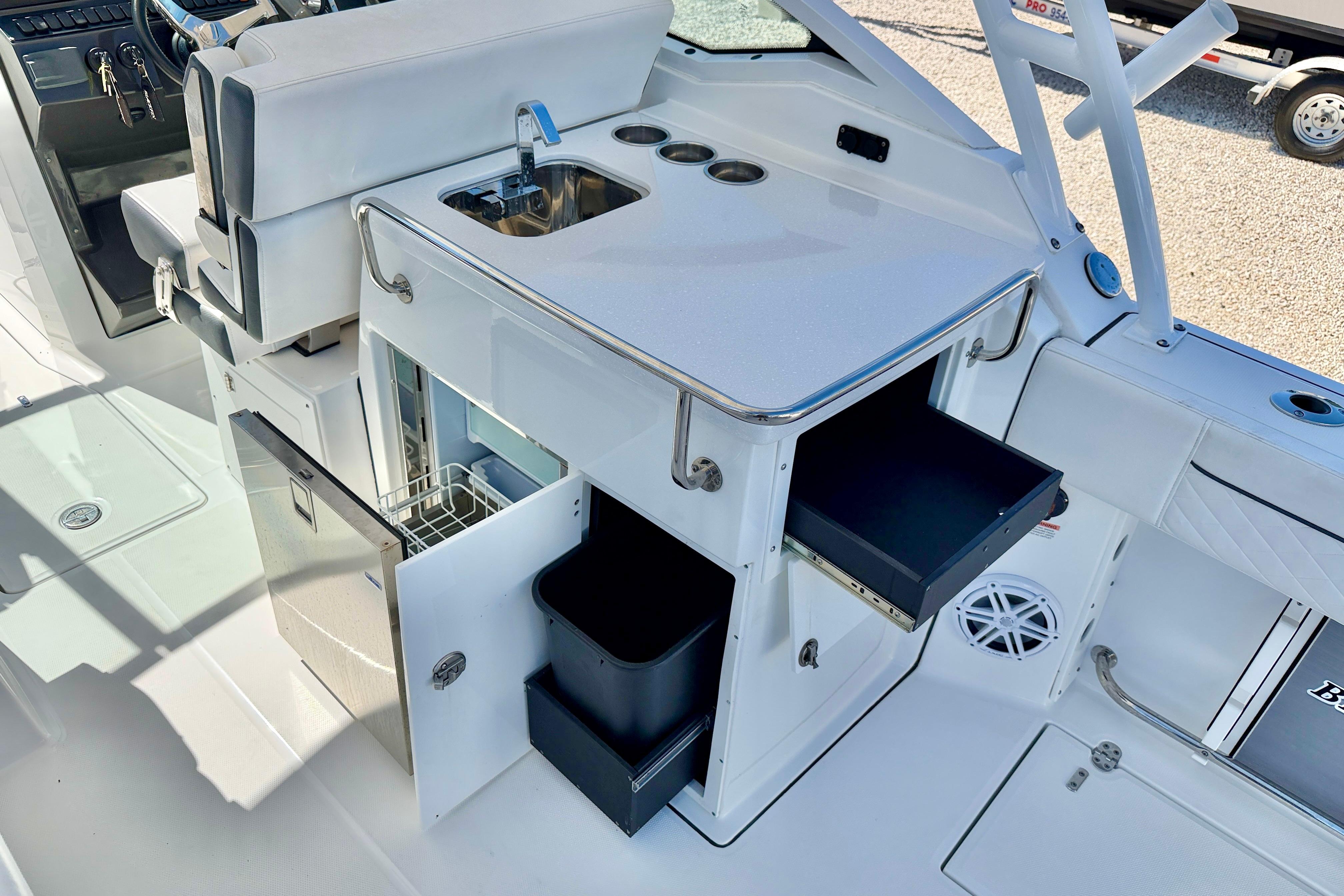 2023 Blackfin 272 DC boat interior with sink, storage, and seating area.