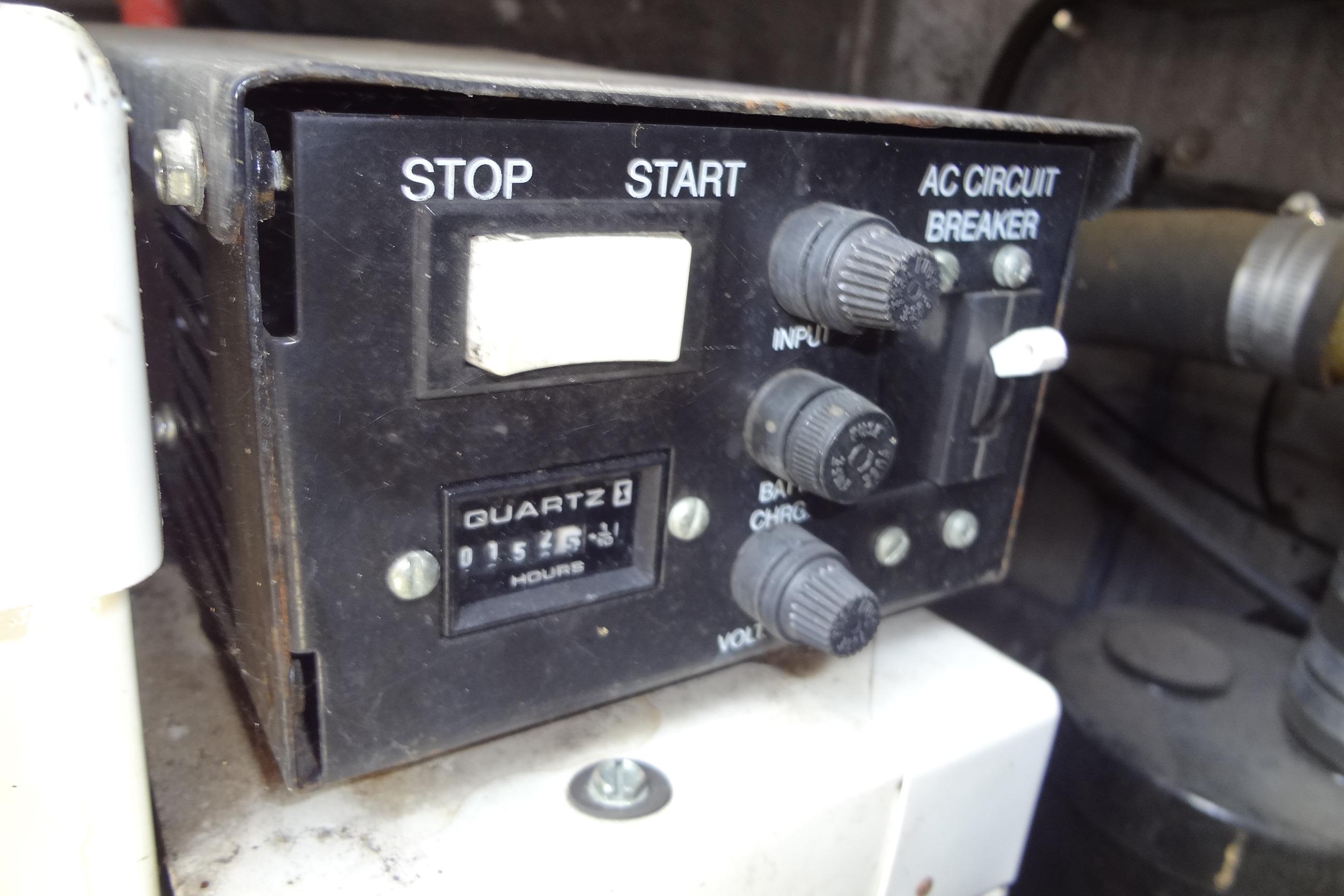 Control panel of a 2000 Chaparral Signature 260 boat with start, stop, and circuit breaker.