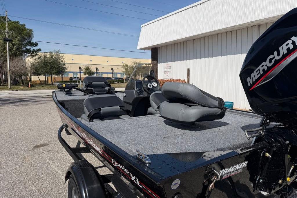 2026 Tracker Bass Tracker Classic XL boat with Mercury engine, parked outdoors.