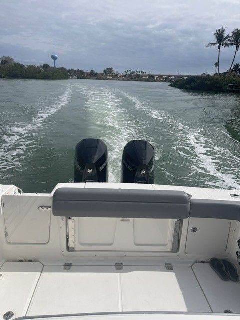 Rear view of a 2023 Boston Whaler 330 Outrage on the water.