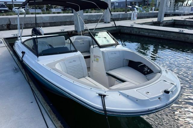 2022 Sea Ray SPX 210 Outboard boat docked at marina, featuring sleek design and spacious seating.