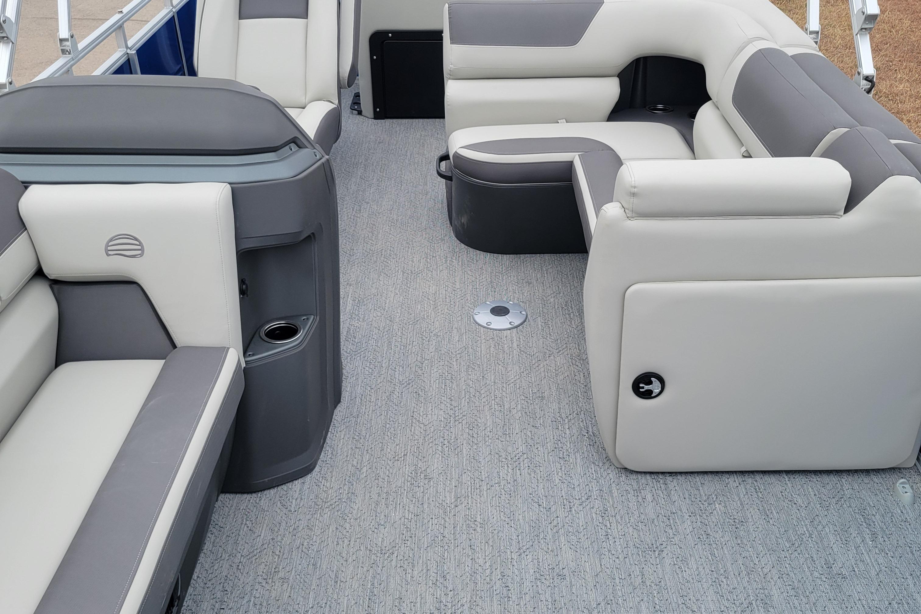 Interior of 2026 Sun Tracker Fishin' Barge 20 DLX with gray and white seating.