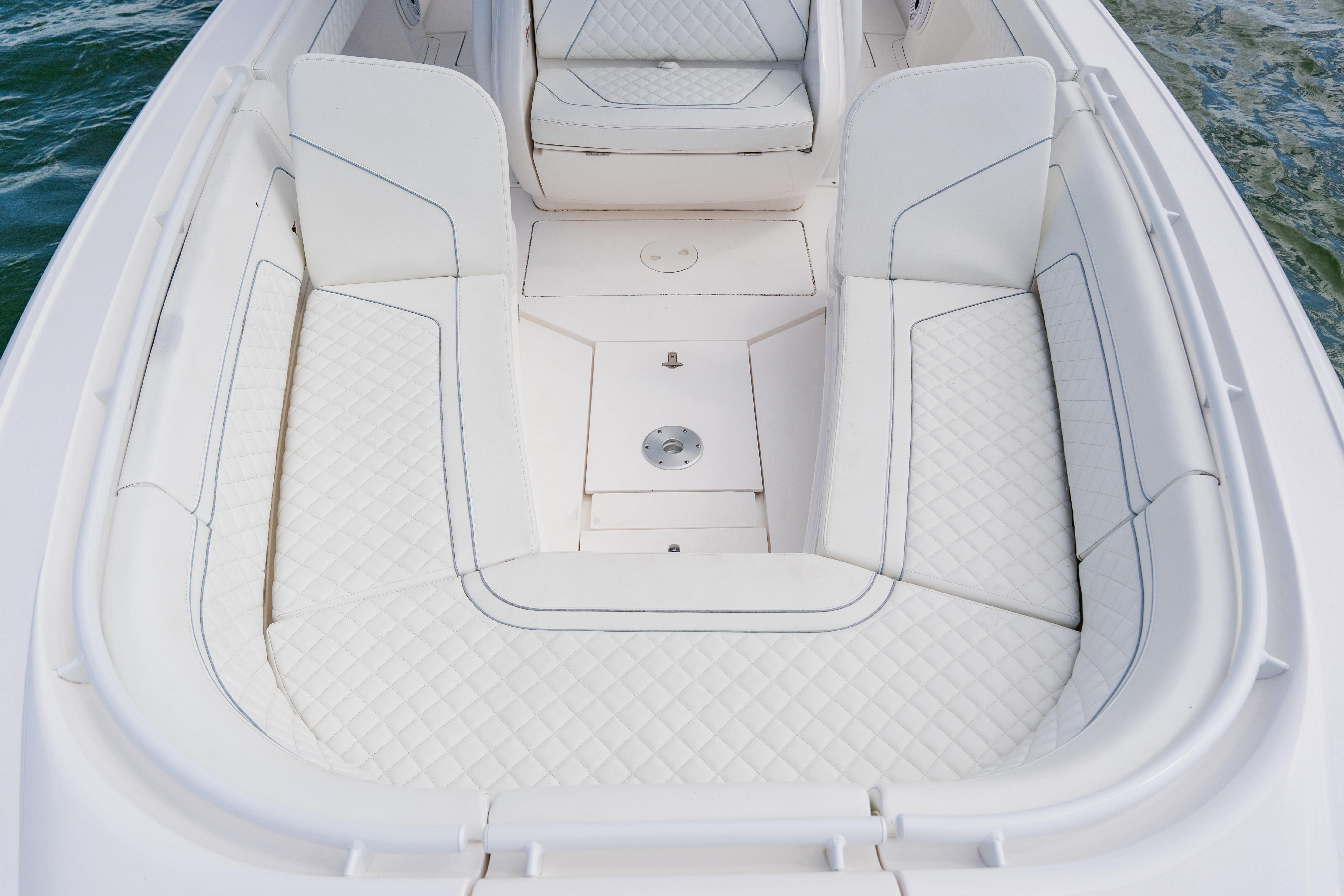 2018 Intrepid 327 Center Console boat with white cushioned seating.