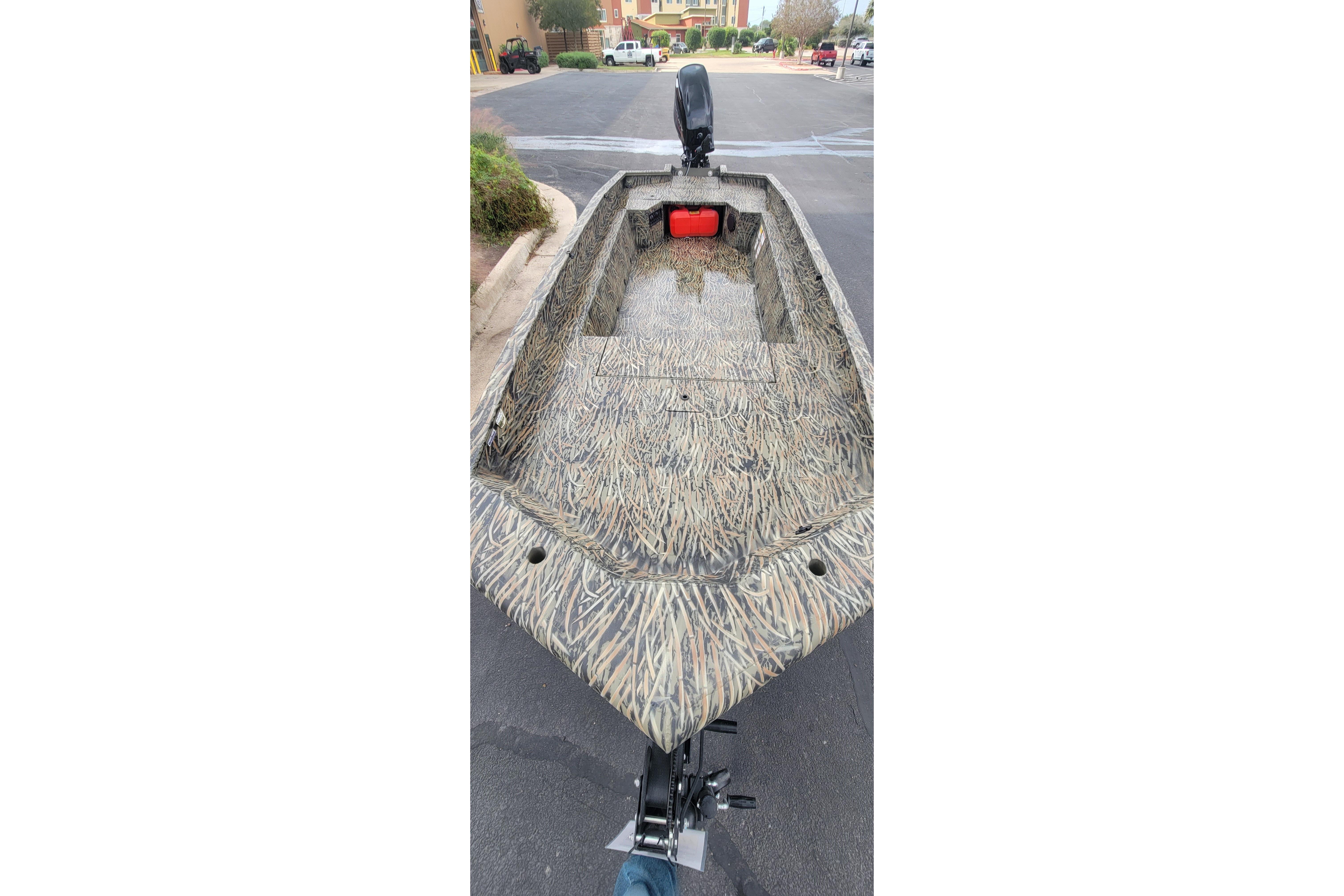 2025 Tracker Grizzly 1650 T Prairie Wings Edition boat with camouflage design on a street.