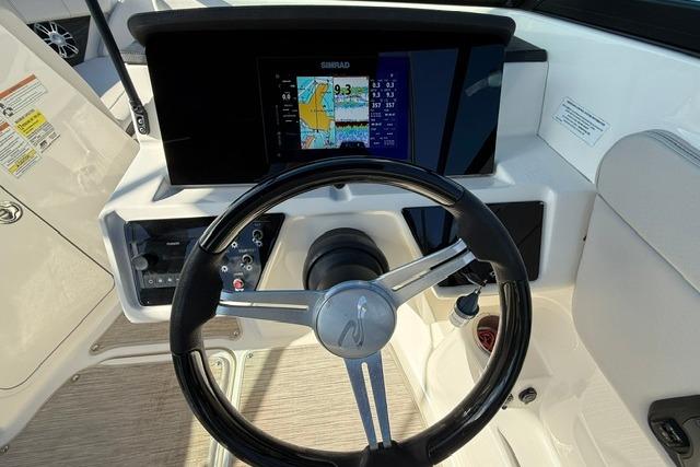 2022 Sea Ray SPX 210 Outboard dashboard with steering wheel and navigation display.