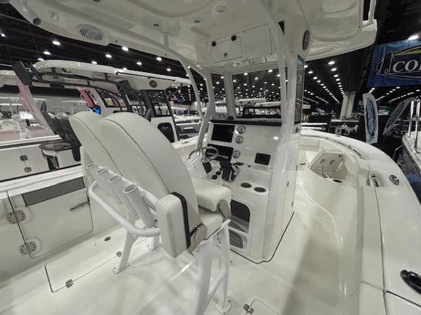 2025 Sea Pro 262 Offshore boat interior with helm, seating, and modern controls at a boat show.