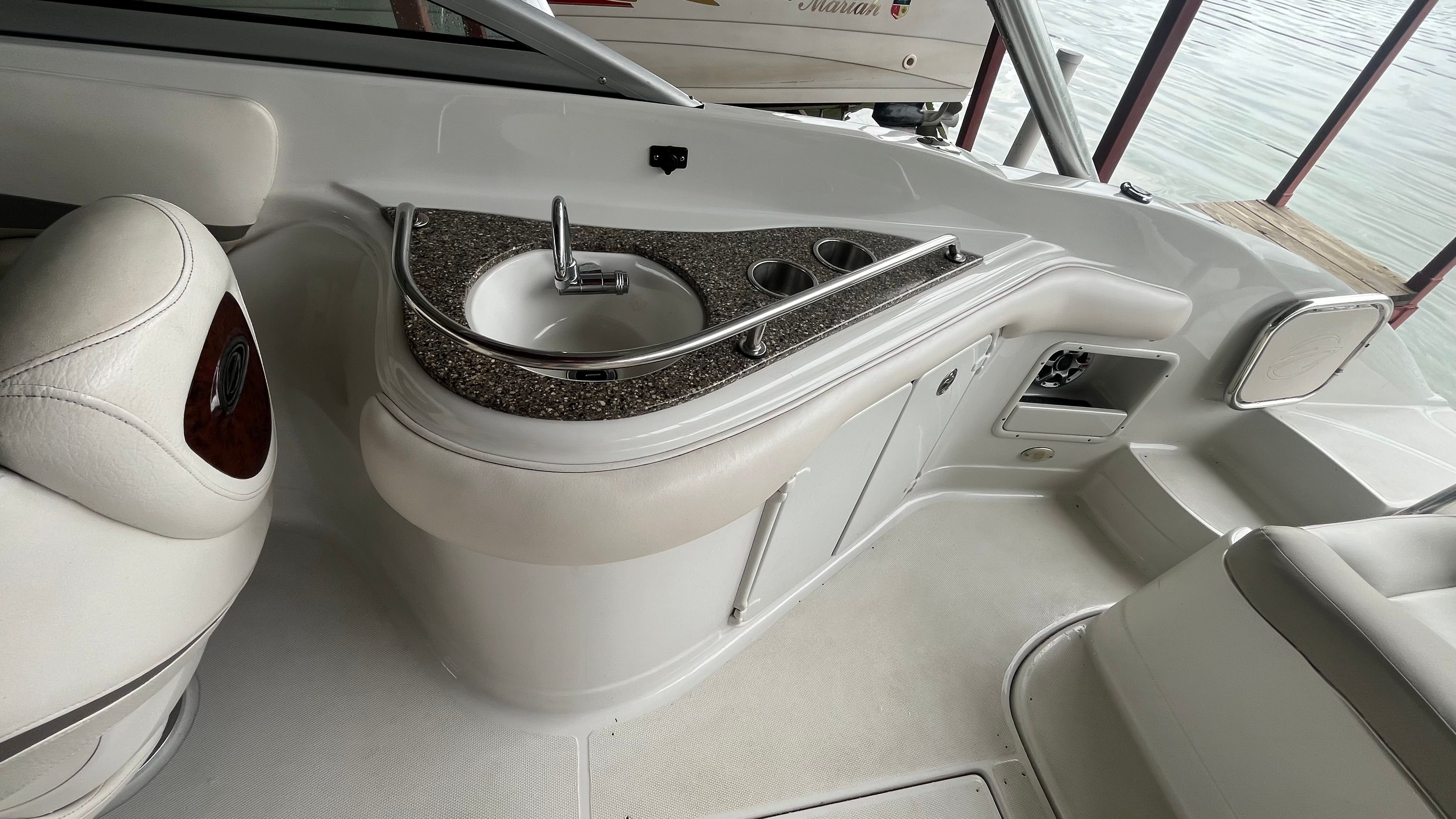 The image shows the cockpit of a 2008 Crownline 252EX with a small sink.