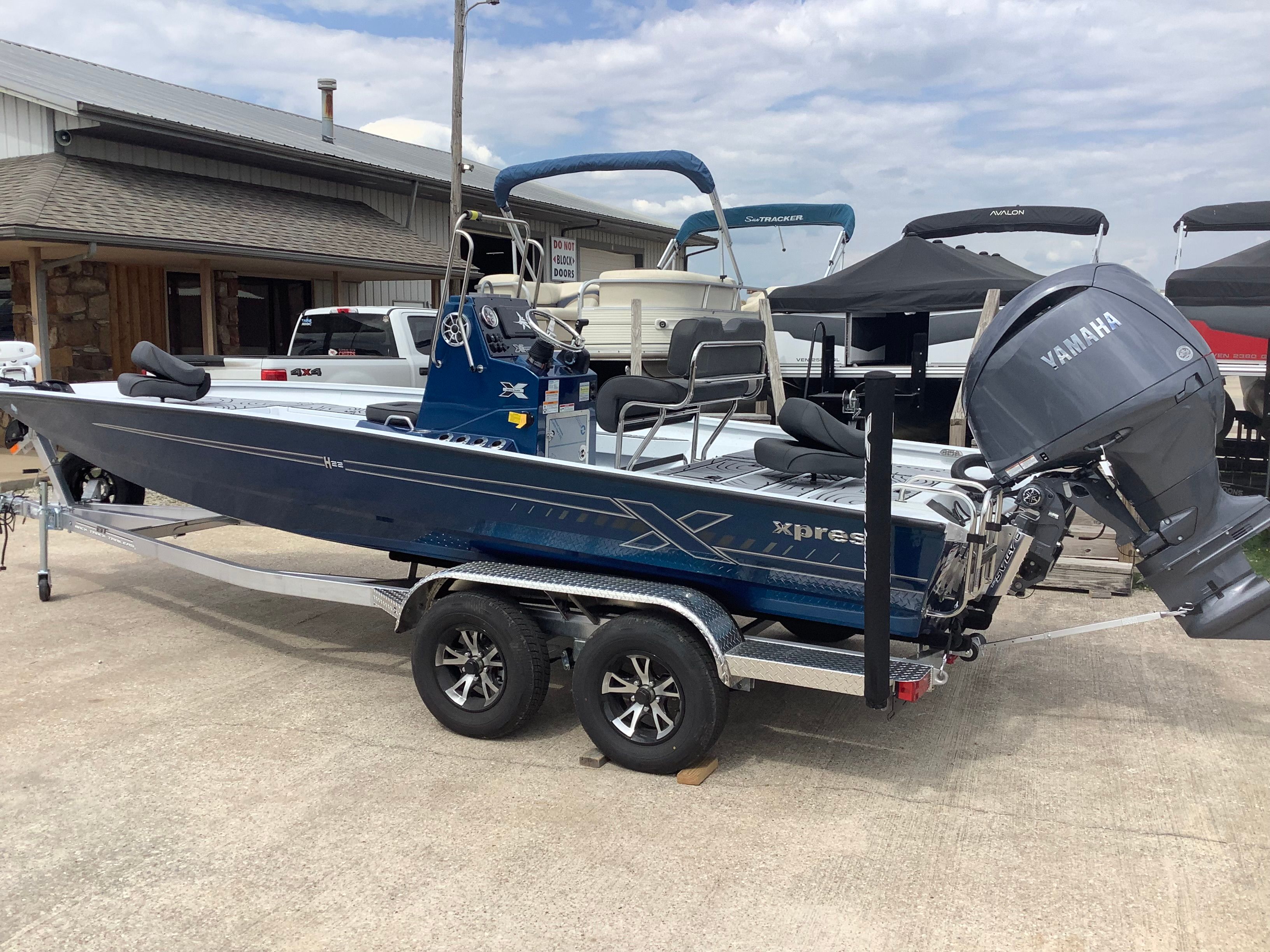 2026 Xpress H22B Bay boat with Yamaha engine on trailer.