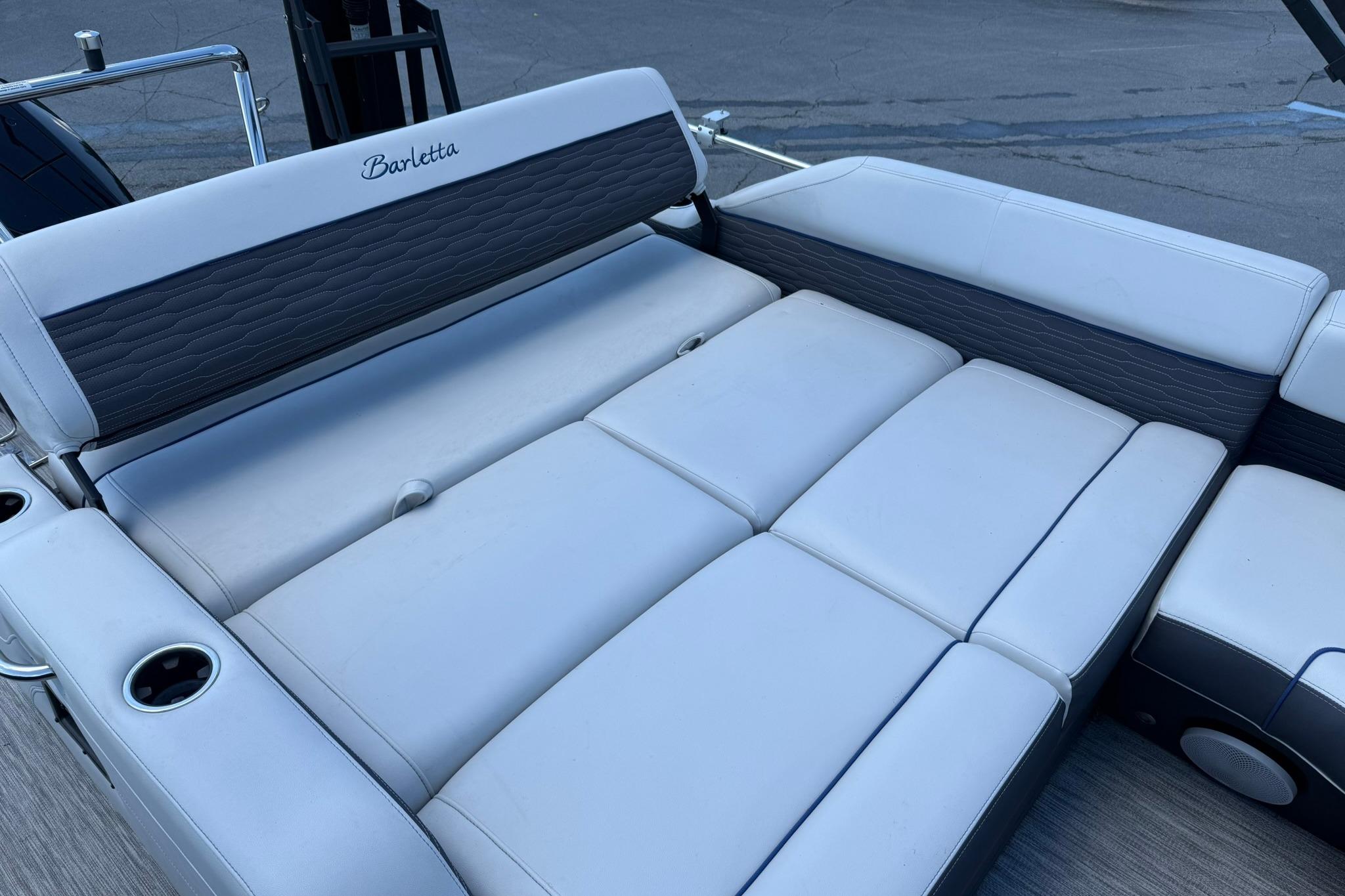 2023 Barletta Corsa 23U boat interior with luxurious white seating and cup holders.