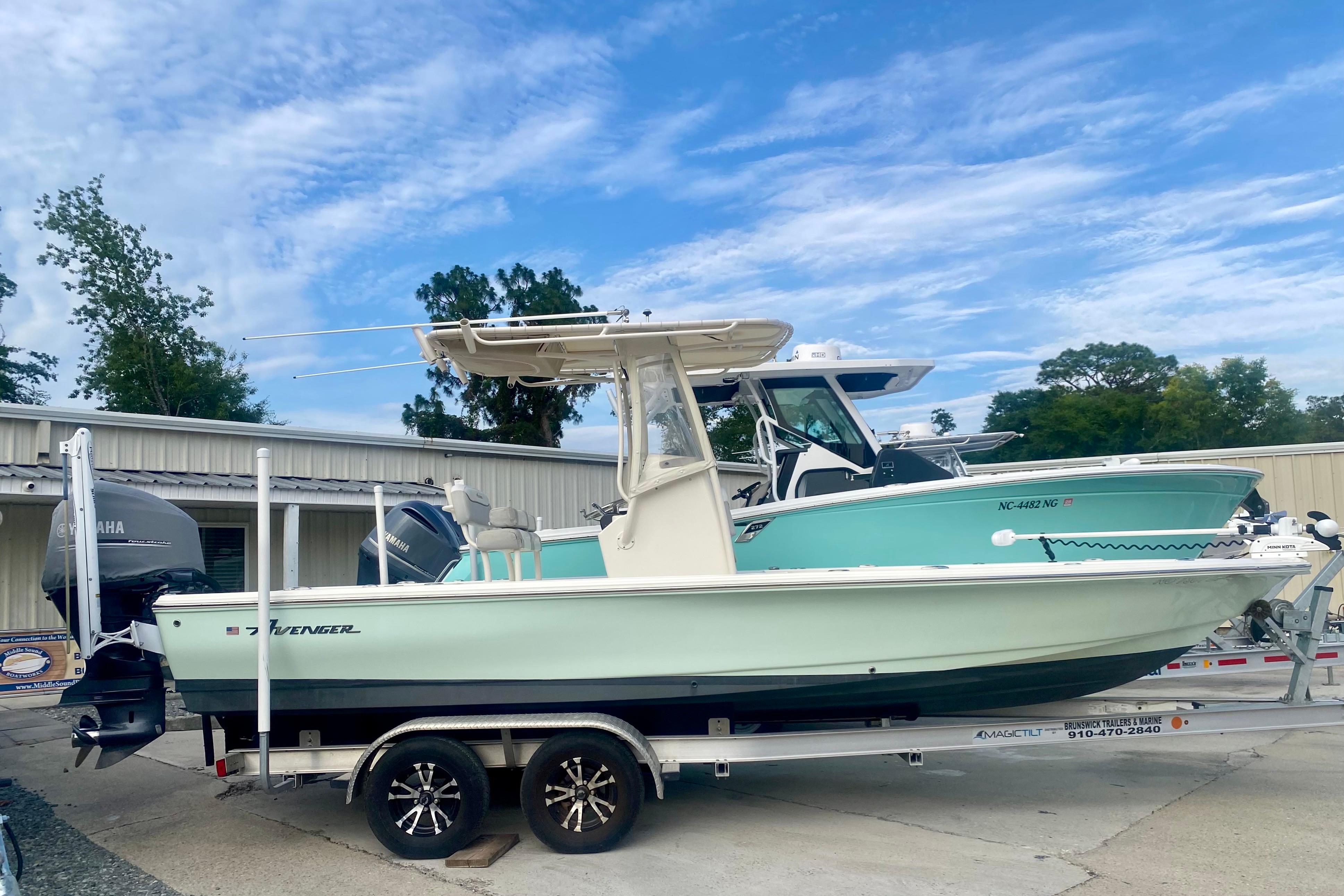 2018 Avenger AV24 boat on trailer, parked outdoors under a clear blue sky.