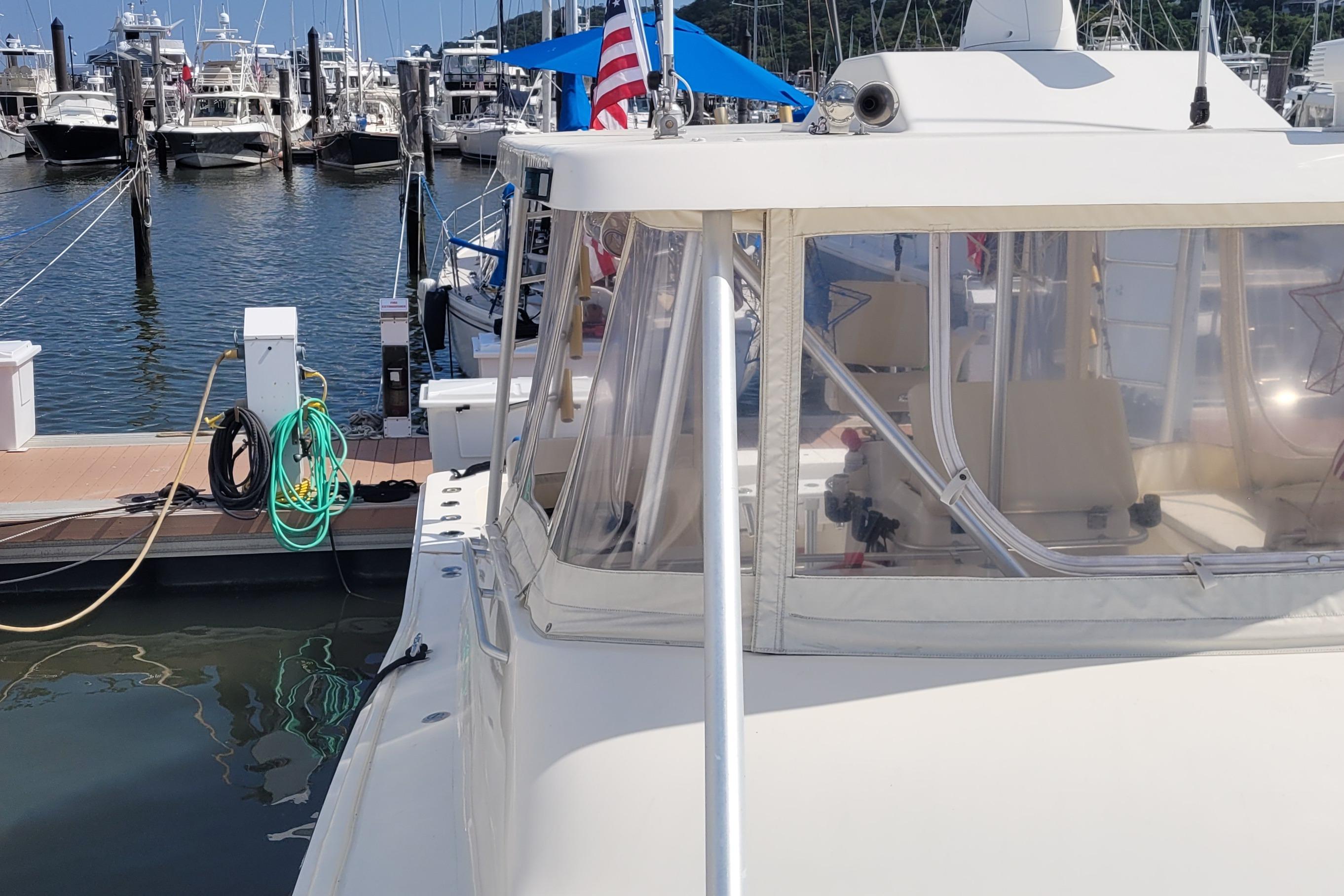 1992 Luhrs 380 Open yacht docked at marina with American flag.