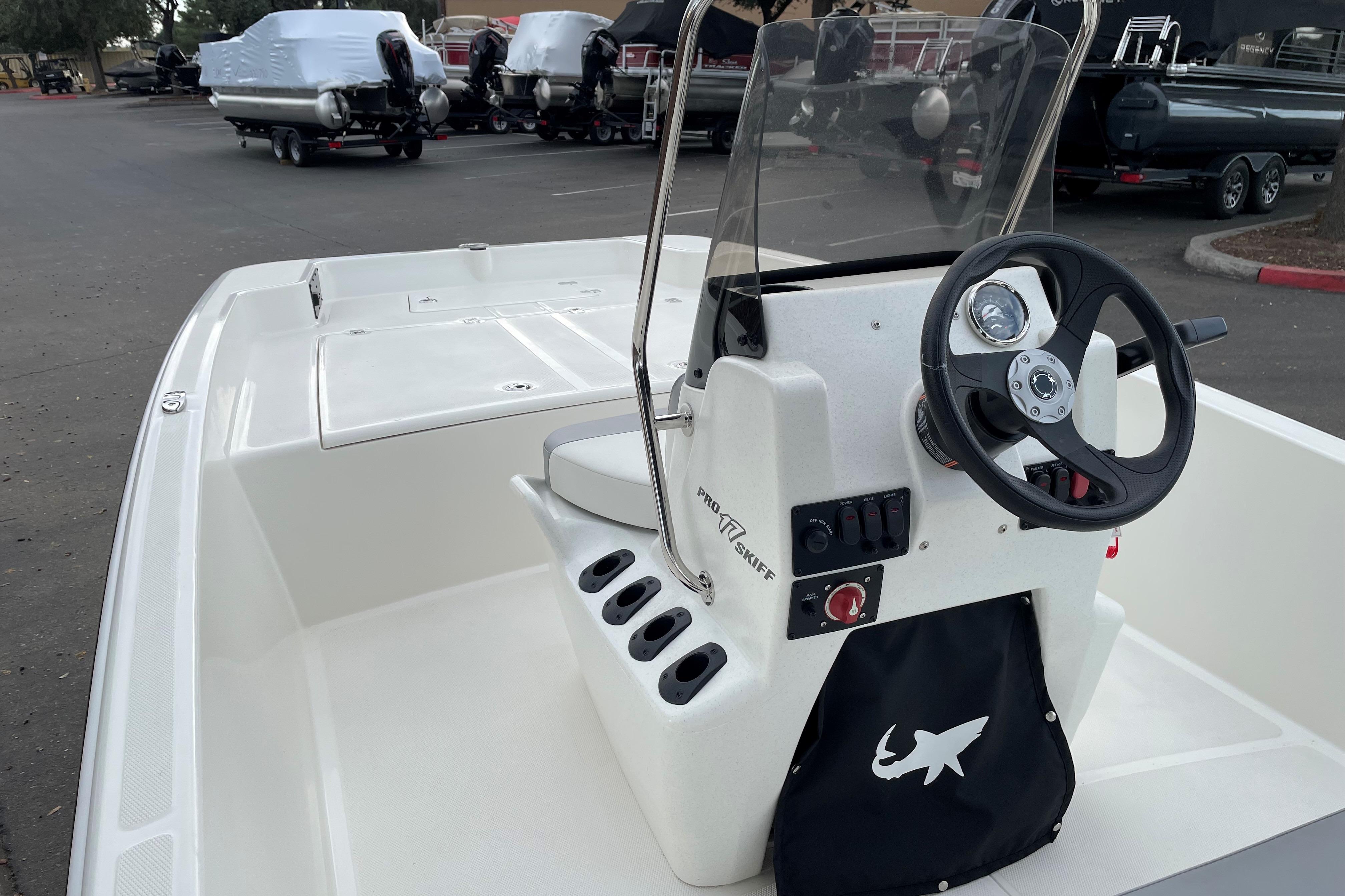 2025 Mako Pro Skiff 17 CC boat interior with steering console and storage.