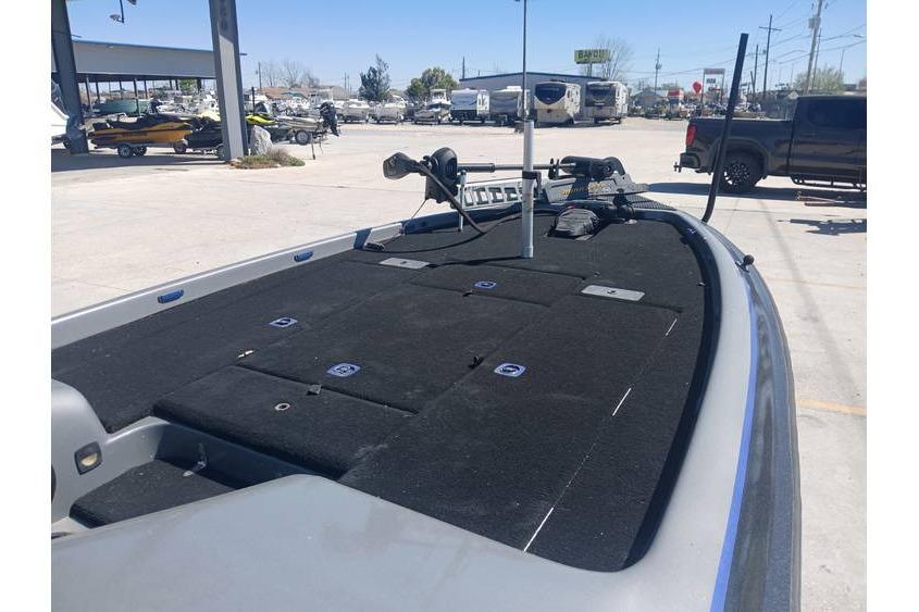 1994 Gambler 21 boat deck with fishing equipment in a parking lot.