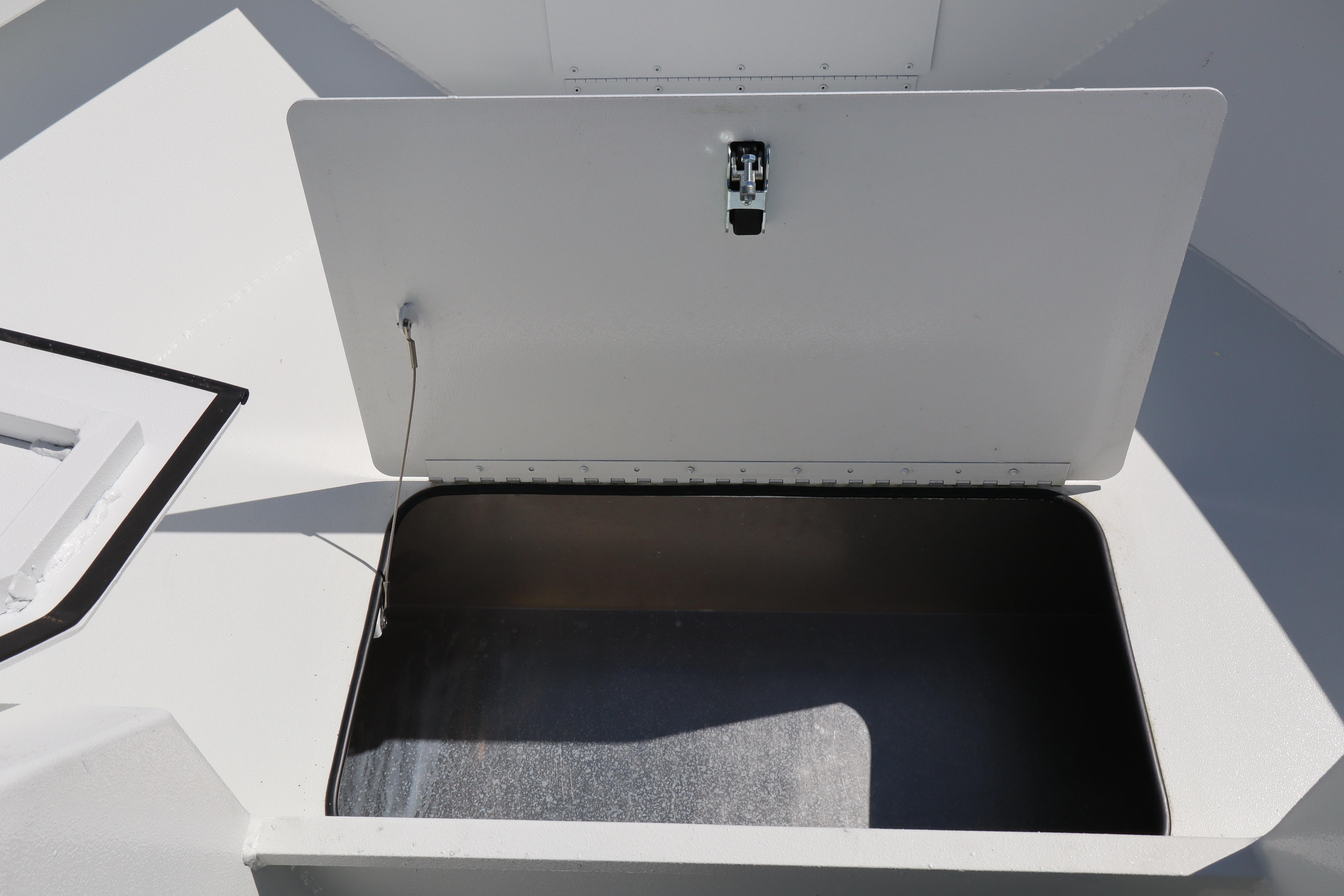 Open storage compartment on 2026 Alumaweld Stryker 202 boat, showcasing interior space.