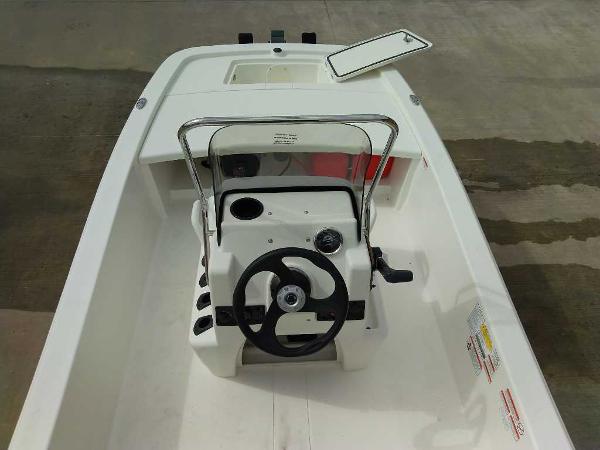 2025 Mako Pro Skiff 13 CC boat interior with steering wheel and console.