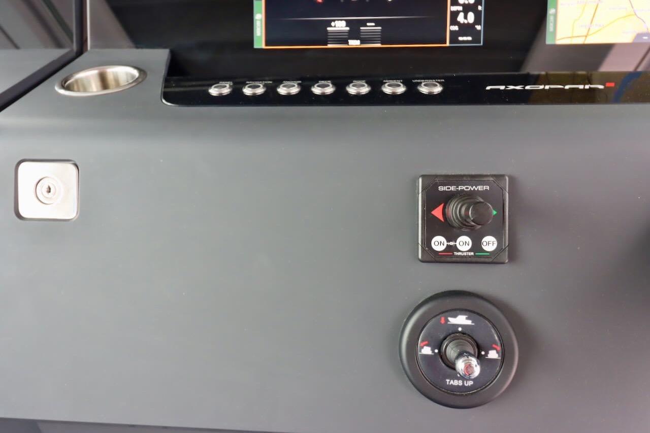 Control panel of 2022 Axopar 37 XC Cross Cabin with side-power and trim tab controls.