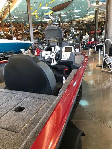 2025 Tracker Pro Team 175 boat with red exterior, displayed indoors.