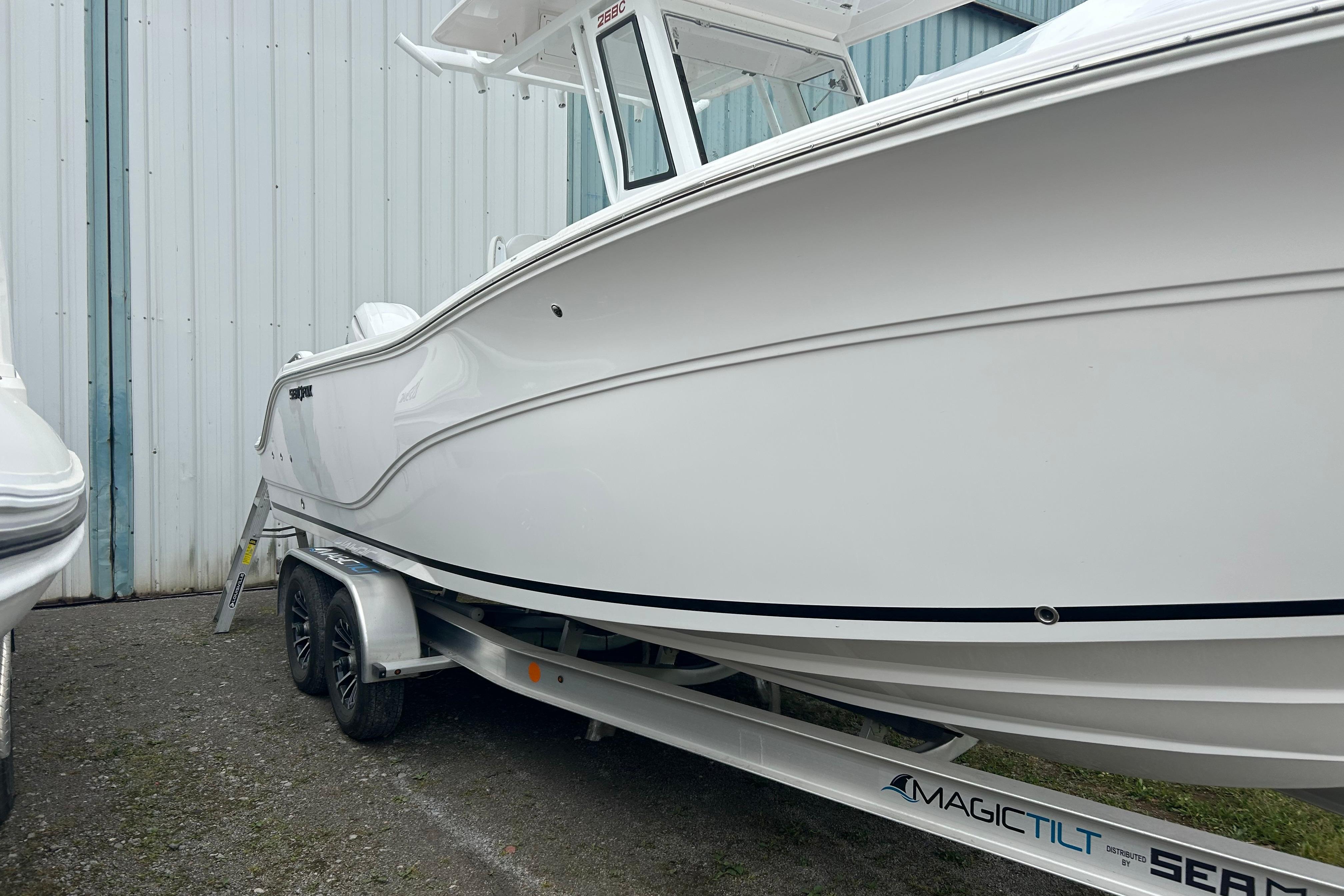 2026 Sea Fox 268 Commander boat on Magic Tilt trailer, parked outdoors.