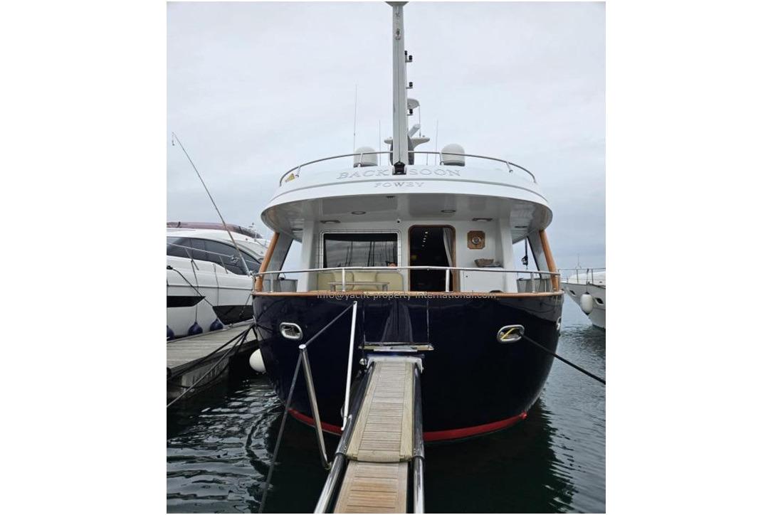 2015 Benetti 79 yacht docked, rear view, showcasing elegant design and spacious deck.