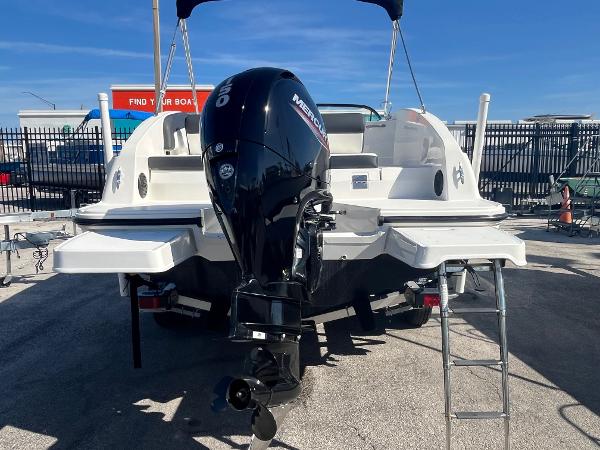 2021 Bayliner DX 2200 boat with Mercury outboard motor, parked on a trailer.