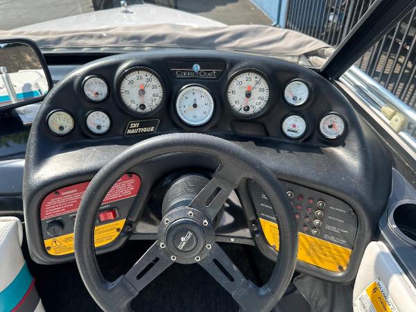 1992 Correct Craft Ski Nautique dashboard with gauges and steering wheel.