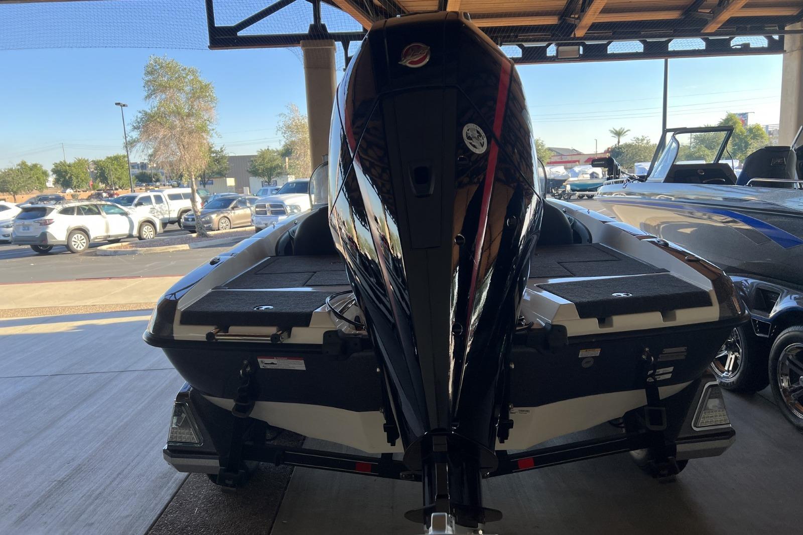 2025 Ranger 212LS boat in showroom, rear view with motor, parked indoors.