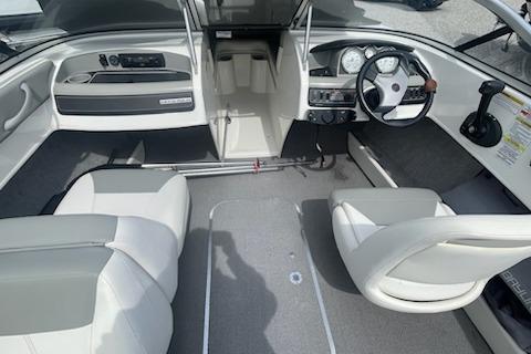 2013 Bayliner 190 Bowrider interior with steering wheel and seating arrangement.