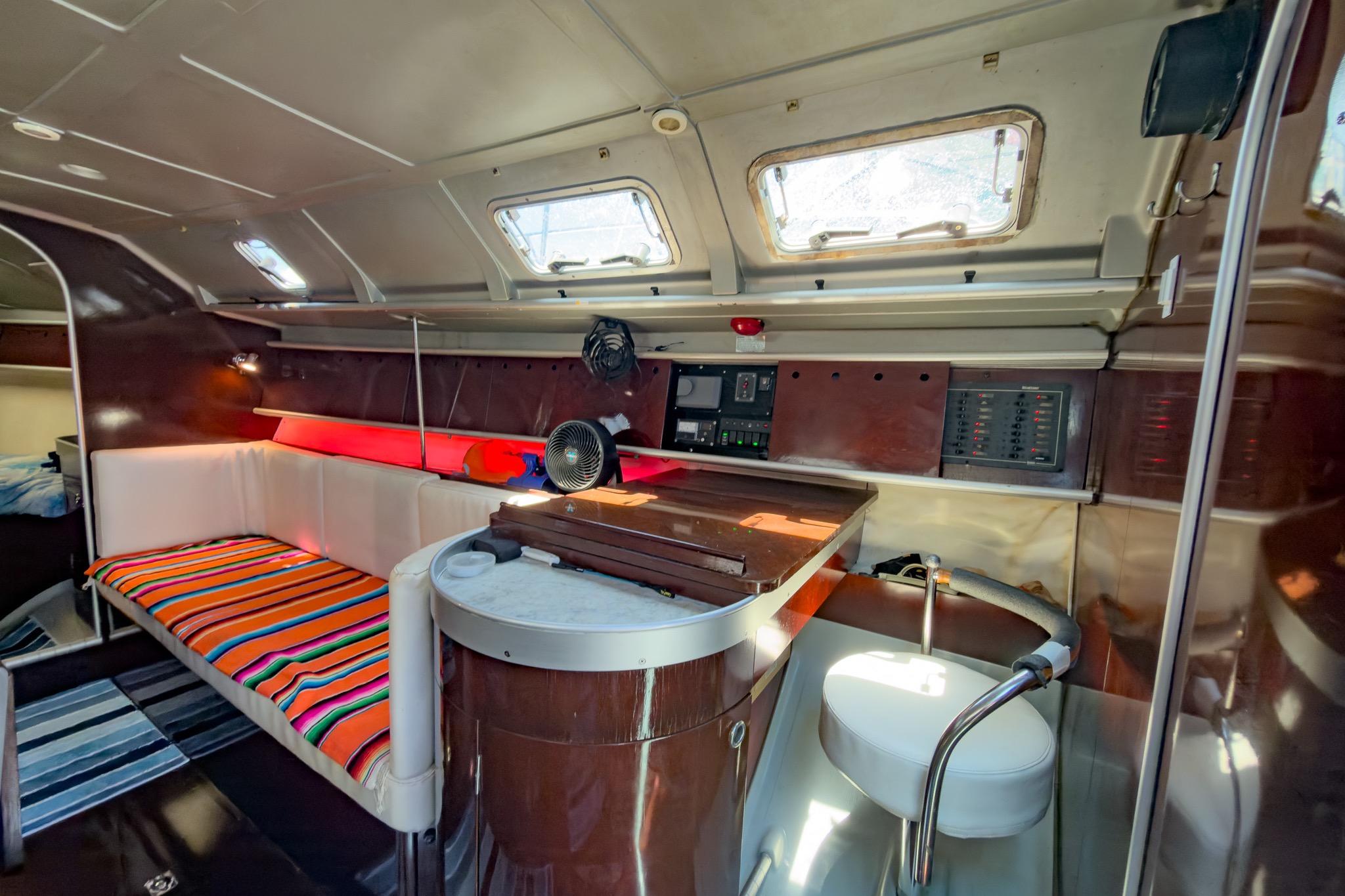 Interior of 1993 Beneteau First 38 s5 yacht with cozy seating and navigation area.