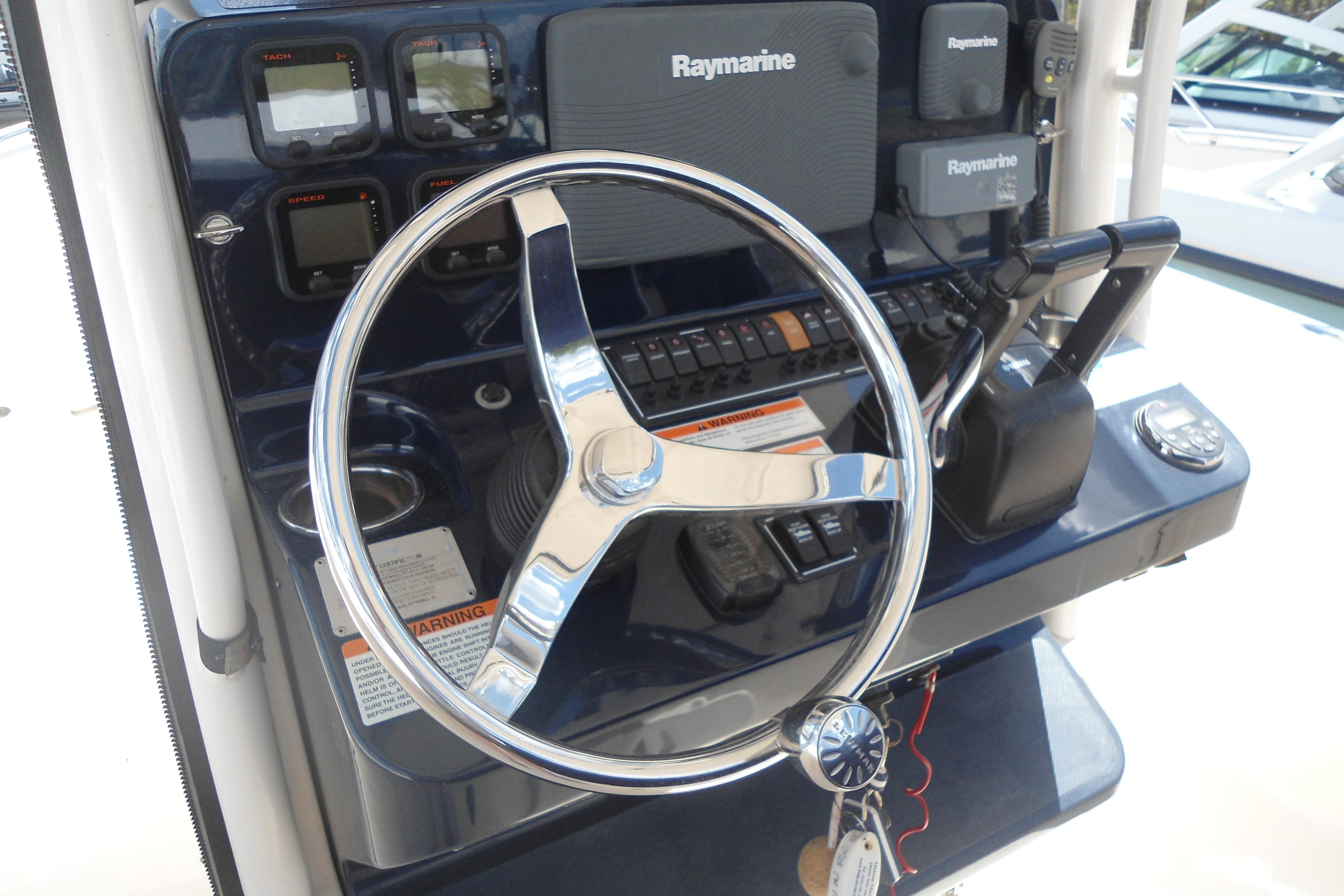 2013 Pursuit C 260 Center Console helm with Raymarine electronics and steering wheel.