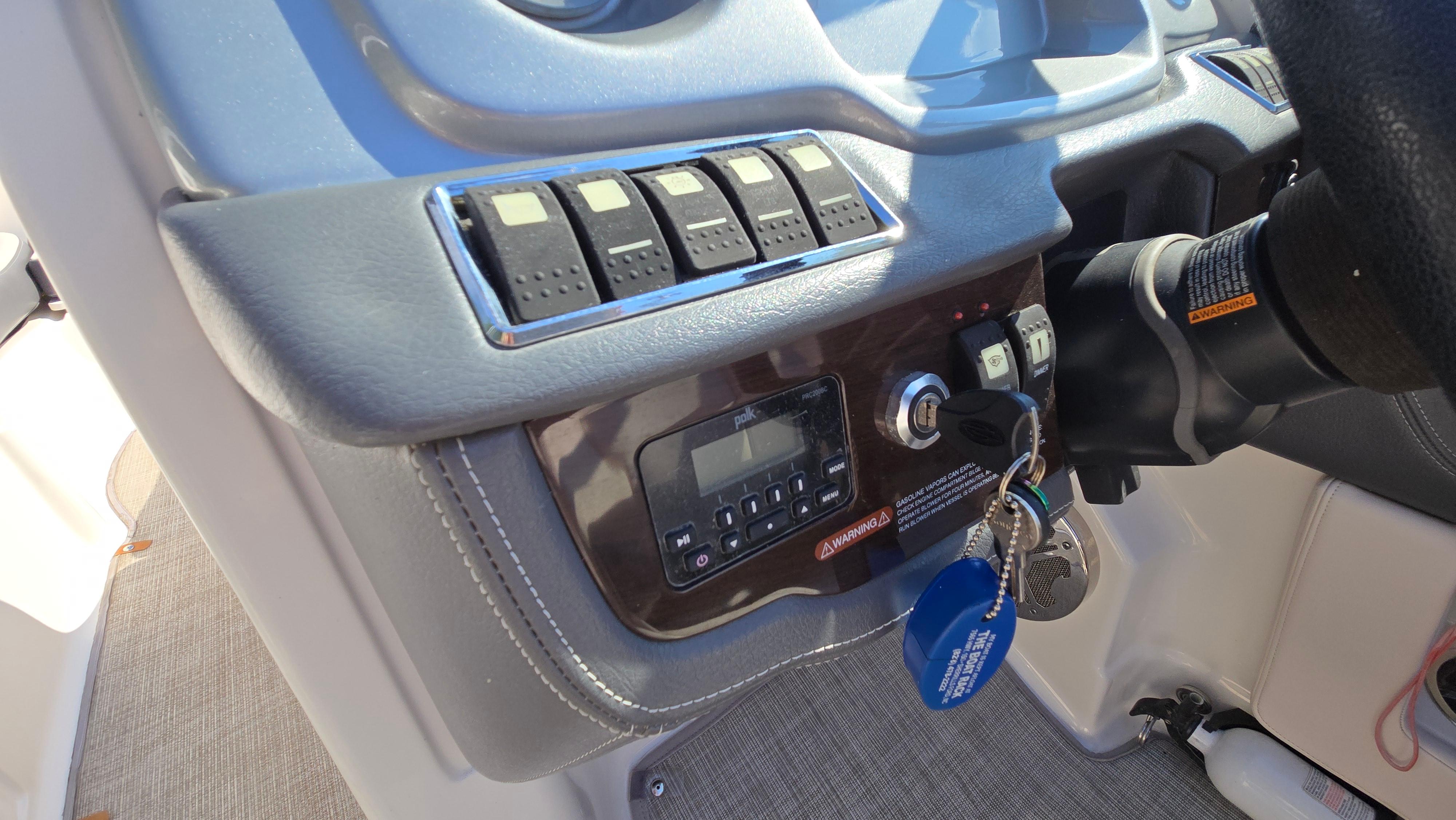 Dashboard of a 2018 Chaparral 224 Sunesta boat with control panel and keys.