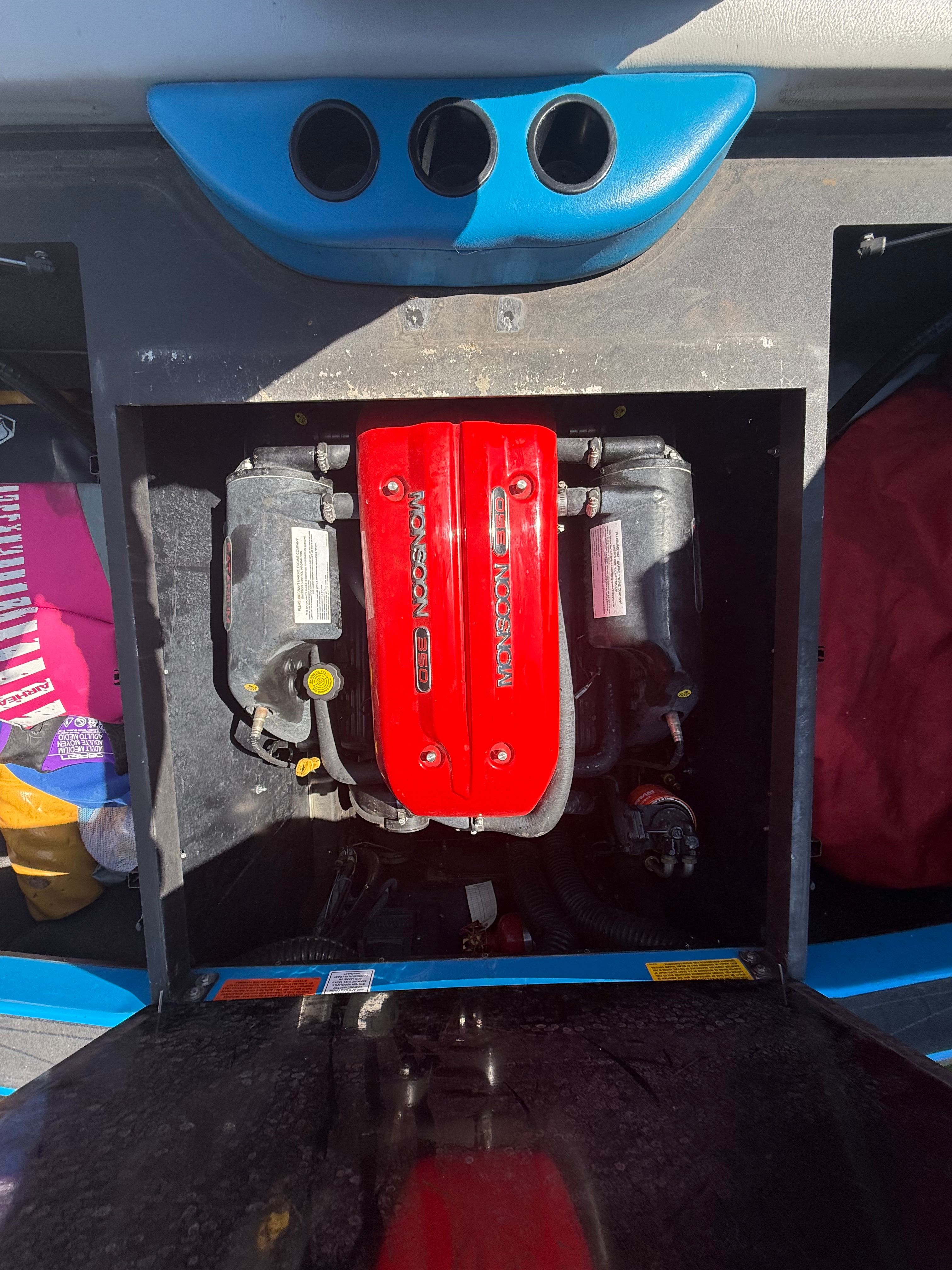 Engine compartment of a 2015 Malibu Axis A20 boat with red Monsoon engine.