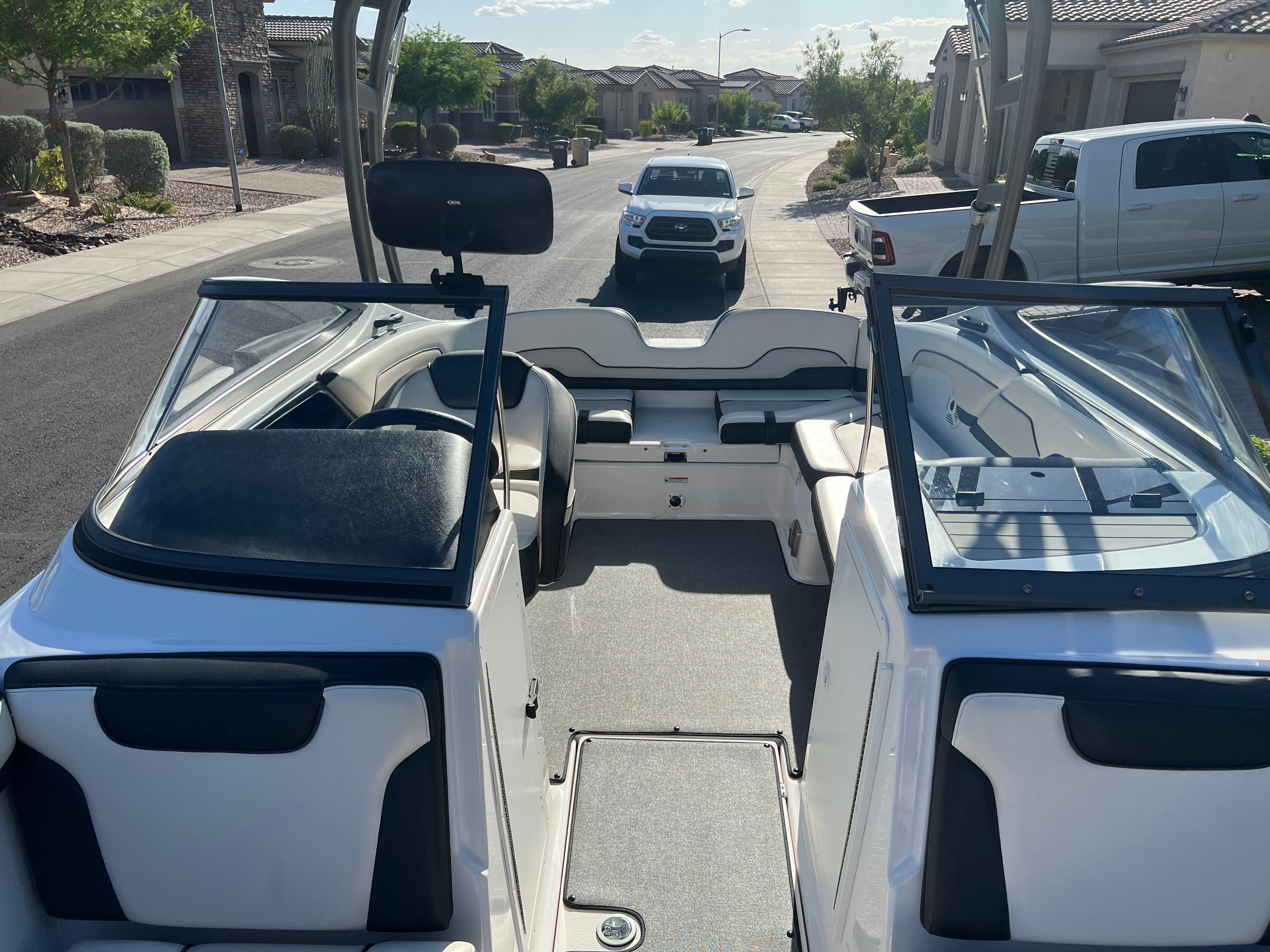 The image shows the cockpit of a 2018 Yamaha AR210 boat parked on a street.